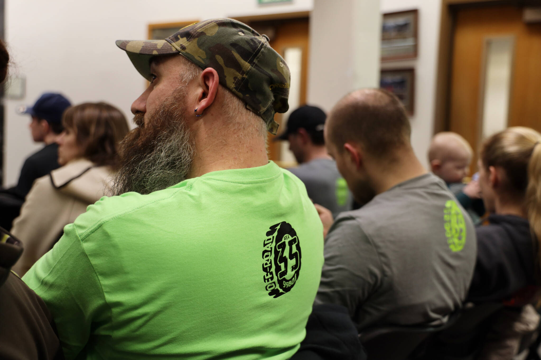 Residents wear matching shirts in advocacy for the proposed off-road vehicle riding park at 35 Mile, which was up for permit consideration and later approved at a January evening Planning Commission meeting. (Clarise Larson / Juneau Empire File)