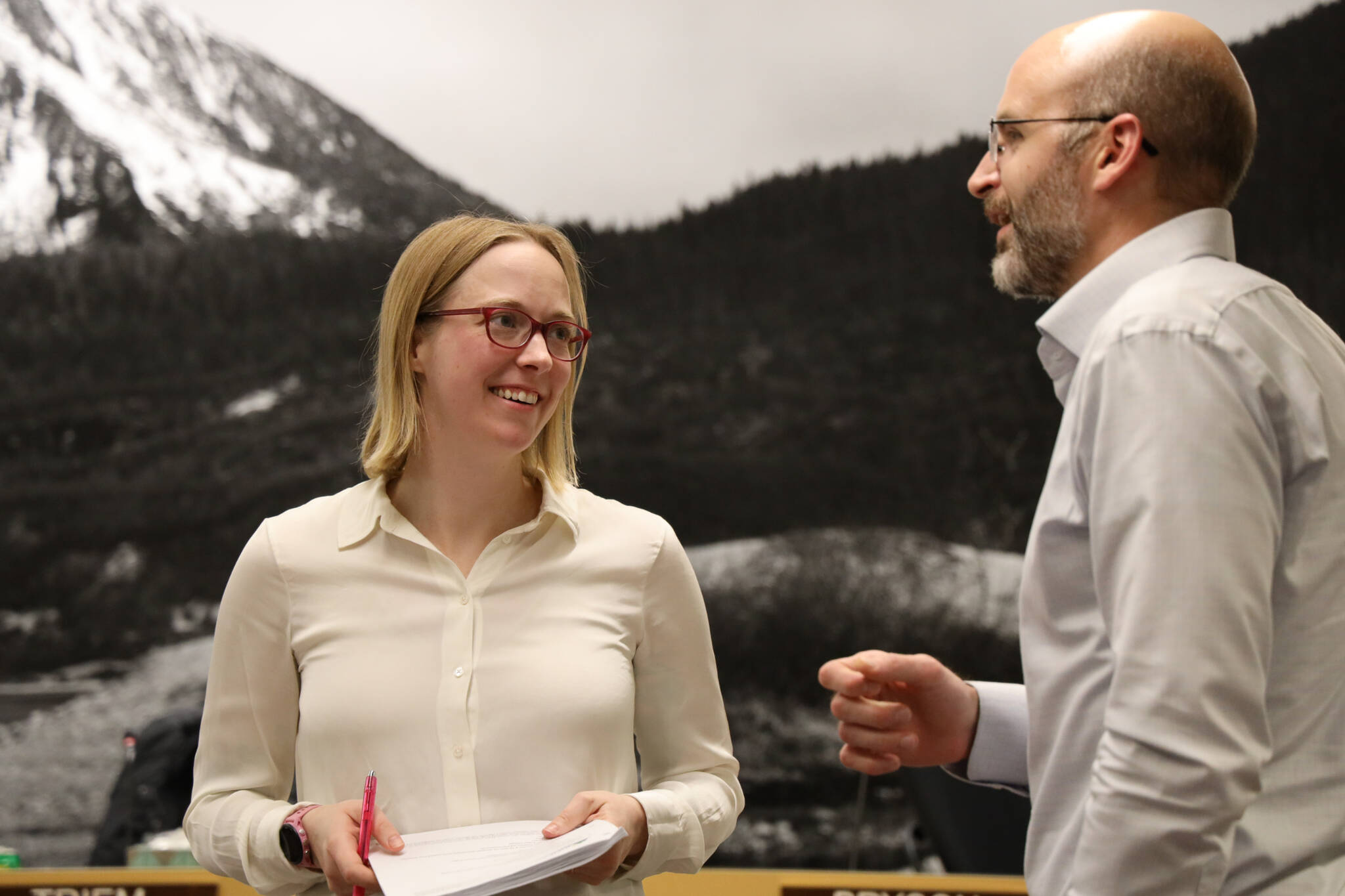 Assembly member Carole Triem chats with Deputy City Manager Robert Barr during a Finance Committee meeting in early May. Triem announced Wednesday she is departing from her role on the Assembly on July 10, citing family medical issues. (Clarise Larson / Juneau Empire File)
