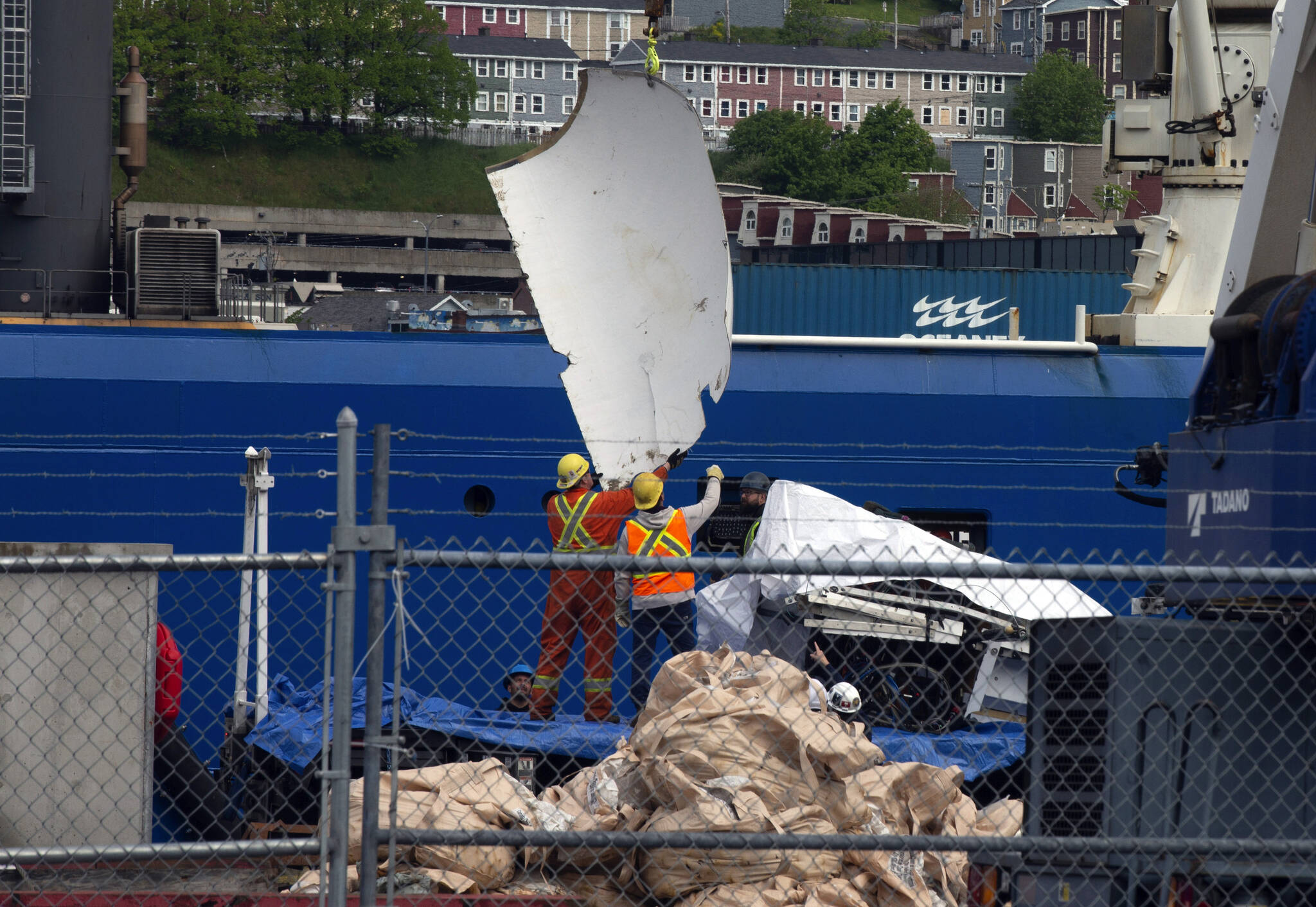 Debris from the Titan submersible, recovered from the ocean floor near the wreck of the Titanic, is unloaded from the ship Horizon Arctic at the Canadian Coast Guard pier in St. Johns, Newfoundland, Wednesday, June 28, 2023. (Paul Daly/The Canadian Press via AP)