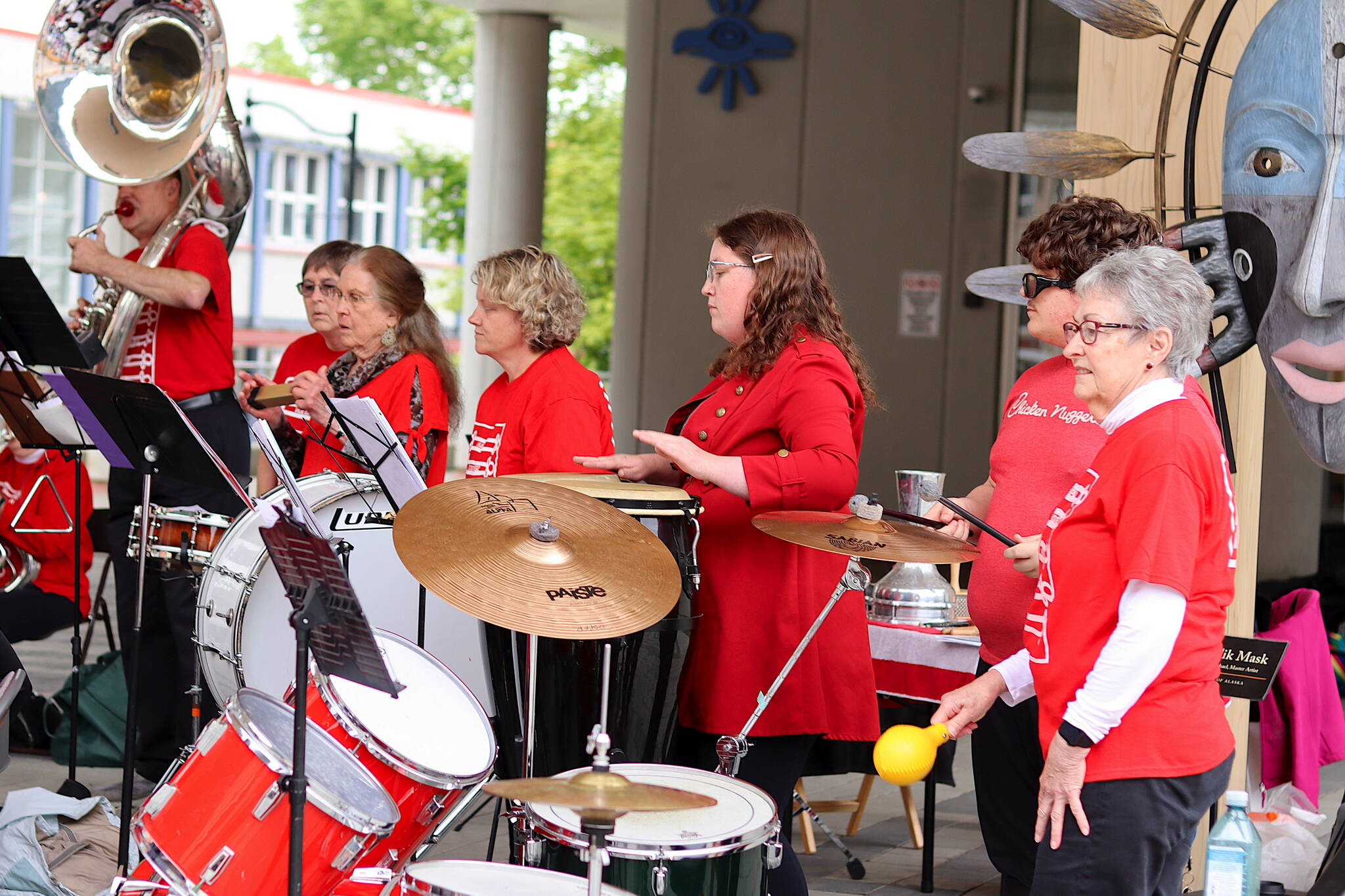 A row of percussion players perform as part of the Juneau Volunteer Marching Band on Sunday at Sealaska Heritage Plaza (Mark Sabbatini / Juneau Empire)