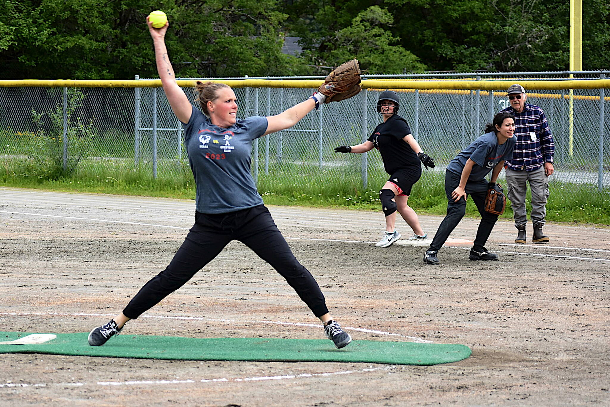 Nicole Adair, a 2001 graduate of Juneau-Douglas High School: Yadaat.at Kalé, pitches for the Antiques as teammate Tania Hansen, a 1998 graduate, plays first base and Angi Thibodeau, a 1999 graduate, awaits an opportunity to advance as a member of the Classics during the fourth annual JDHS Softball Alumni Game on Sunday at Melvin Park. (Photo courtesy of JDHS softball)