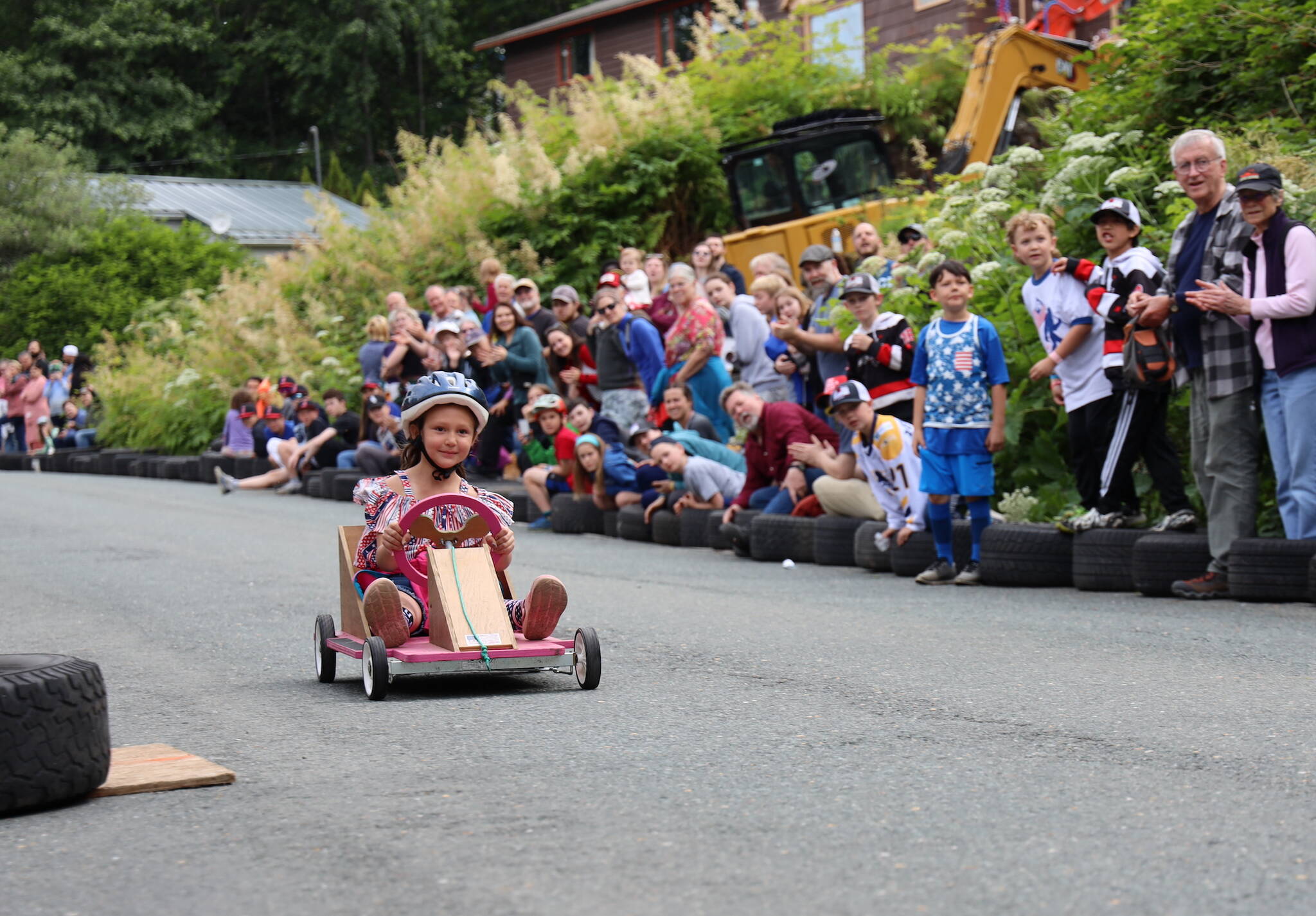 Leadonna Castillo crosses the finish line during the Final Soapbox Challenge Tuesday afternoon down St. Ann’s Avenue in Douglas. (Clarise Larson / Juneau Empire)