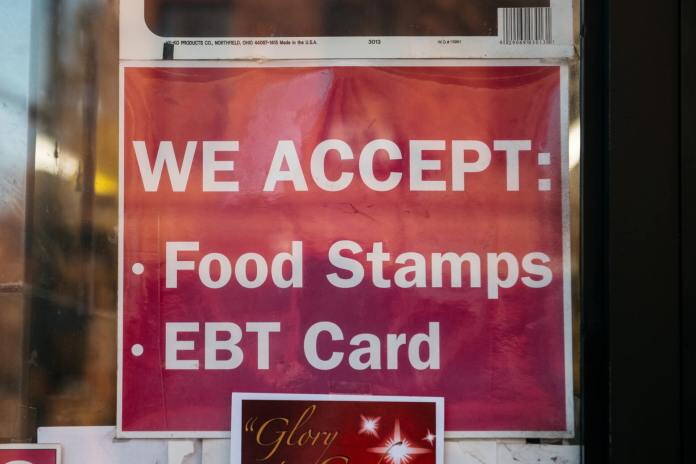 A sign for a store that accepts food stamps and exchange benefits transfer cards is seen in this 2019 photo. Ten Alaskans are suing the state over its failure to provide food stamps within the time frames required by federal law. (Photo by Scott Heins/Getty Images)