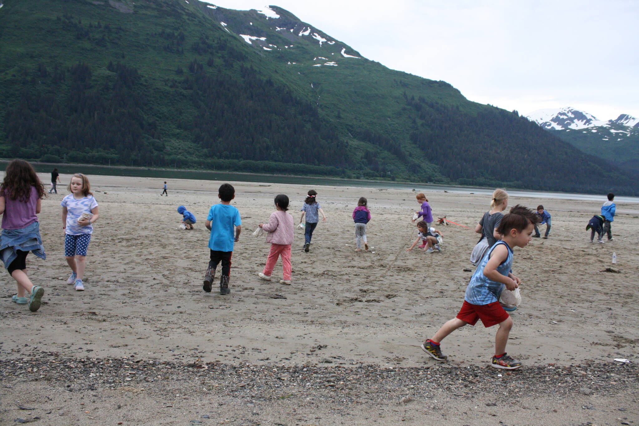 Children pick up sand dollars on Sandy Beach on July 3. The end of this week is expected to be ideal beach weather with near-record temperatures forecast in Juneau and elsewhere in Southeast Alaska. (Therese Pokorney / Juneau Empire File)
