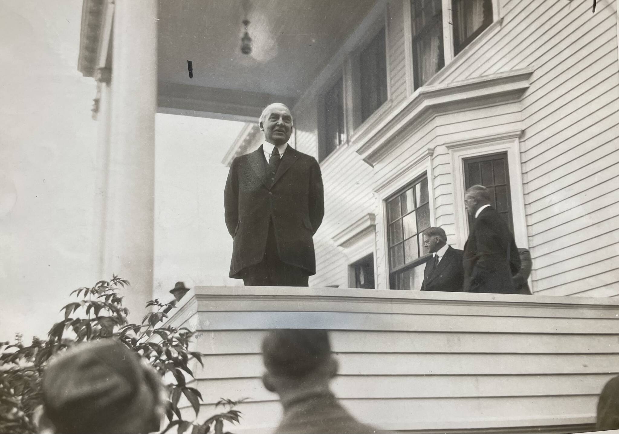President Warren G. Harding speaks to a rain-drenched crowd from the porch of the Governor’s House on Calhoun Avenue on July 10, 1923. He was accompanied on his “Voyage of Understanding” by several cabinet members including Secretary of Commerce Herbert Hoover, whose profile is seen clearly in the background. Harding was the country’s 29th president. Hoover was elected the 31st. (Alaska State Library Historical Collection P418-2.)