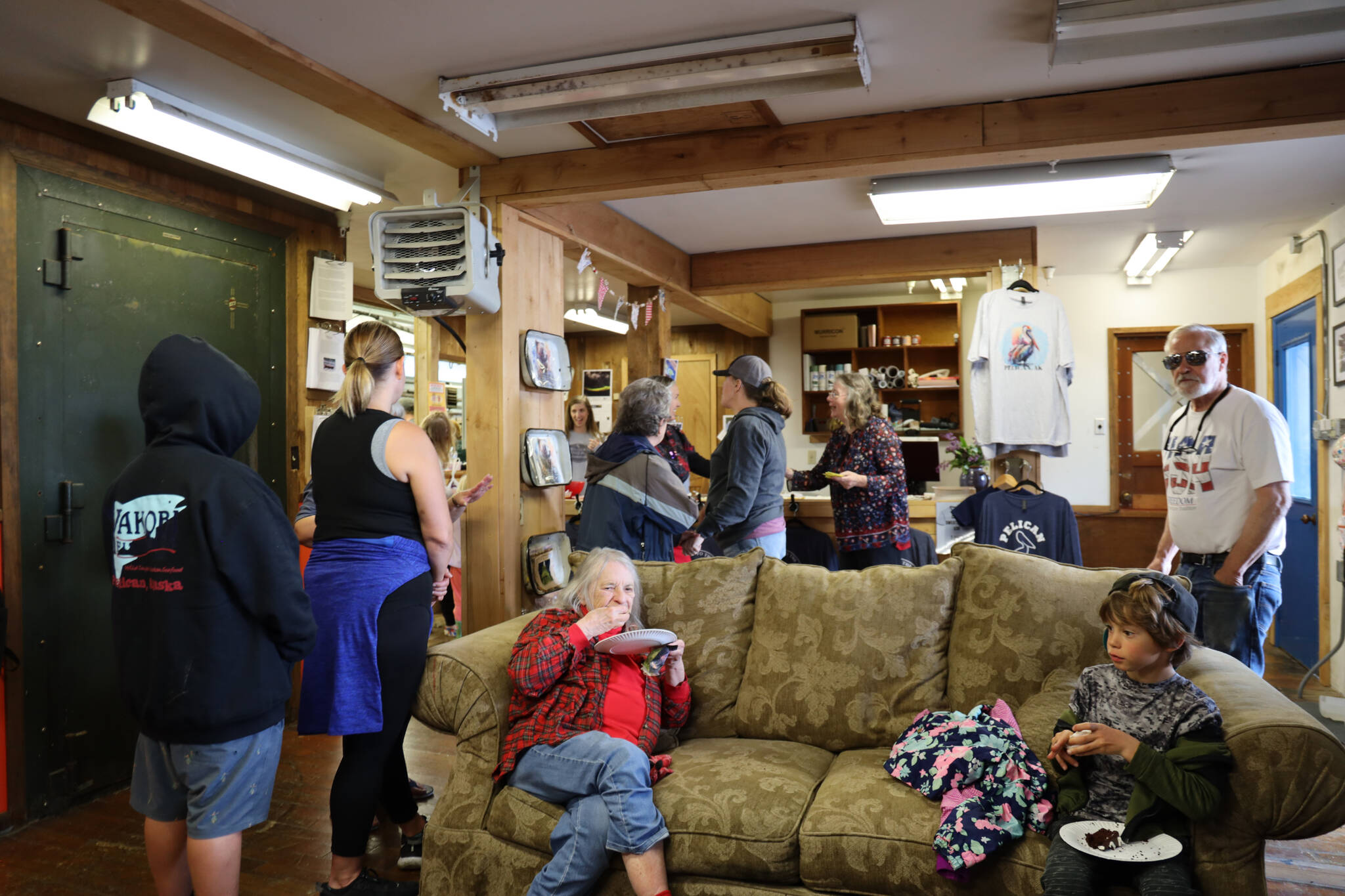 Residents gather for a potluck Monday afternoon to celebrate the grand opening of Pelican General, the town’s first general store to open in 15 years. (Clarise Larson / Juneau Empire)