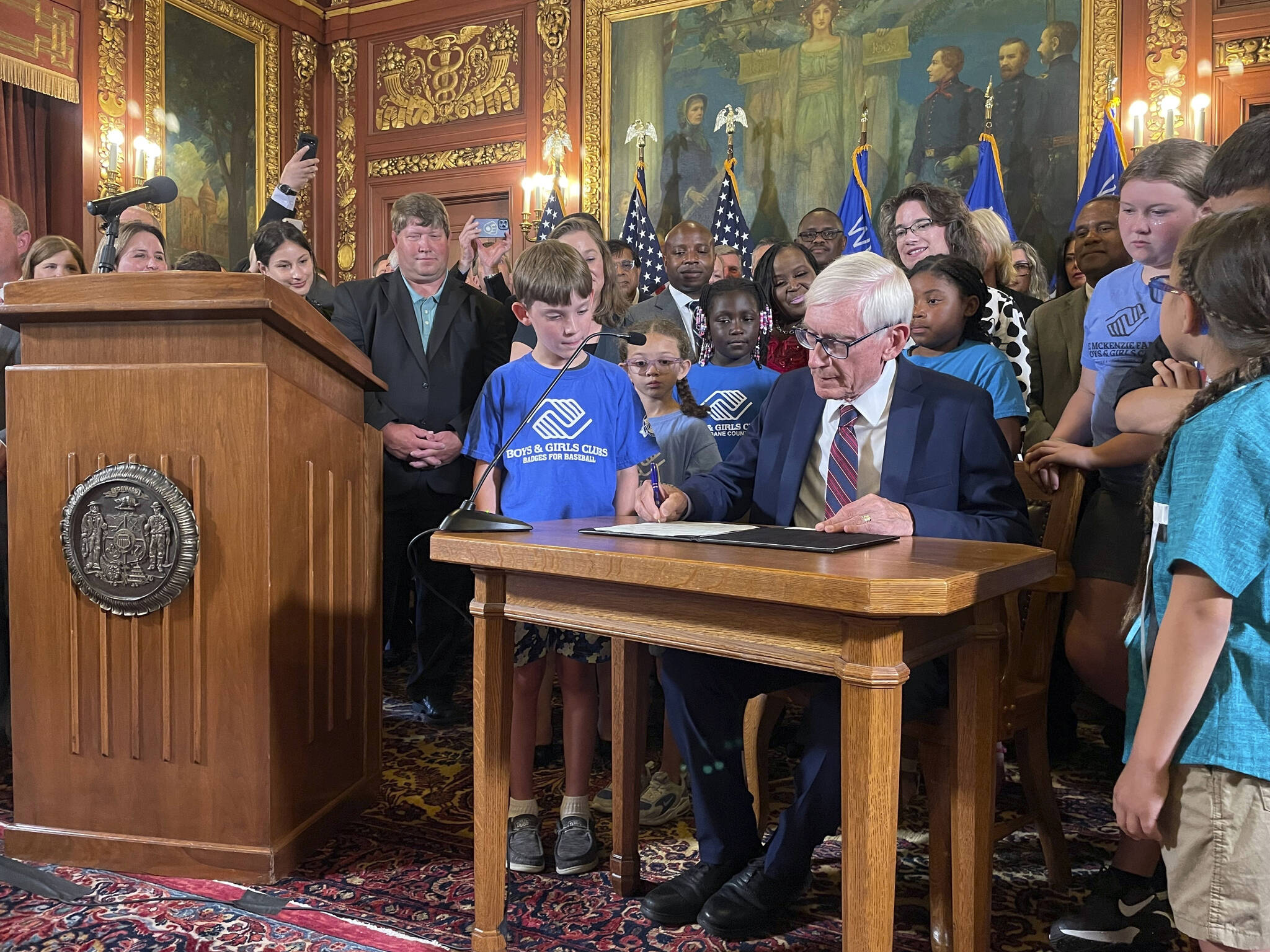 Democratic Wisconsin Gov. Tony Evers signed a two-year spending plan into law Wednesday in Madison, Wis. The budget was authored by Republicans who control the Legislature, but Evers used his partial veto powers to revise portions of it, including locking in annual education funding increases until the year 2425. (AP Photo/Harm Venhuizen)