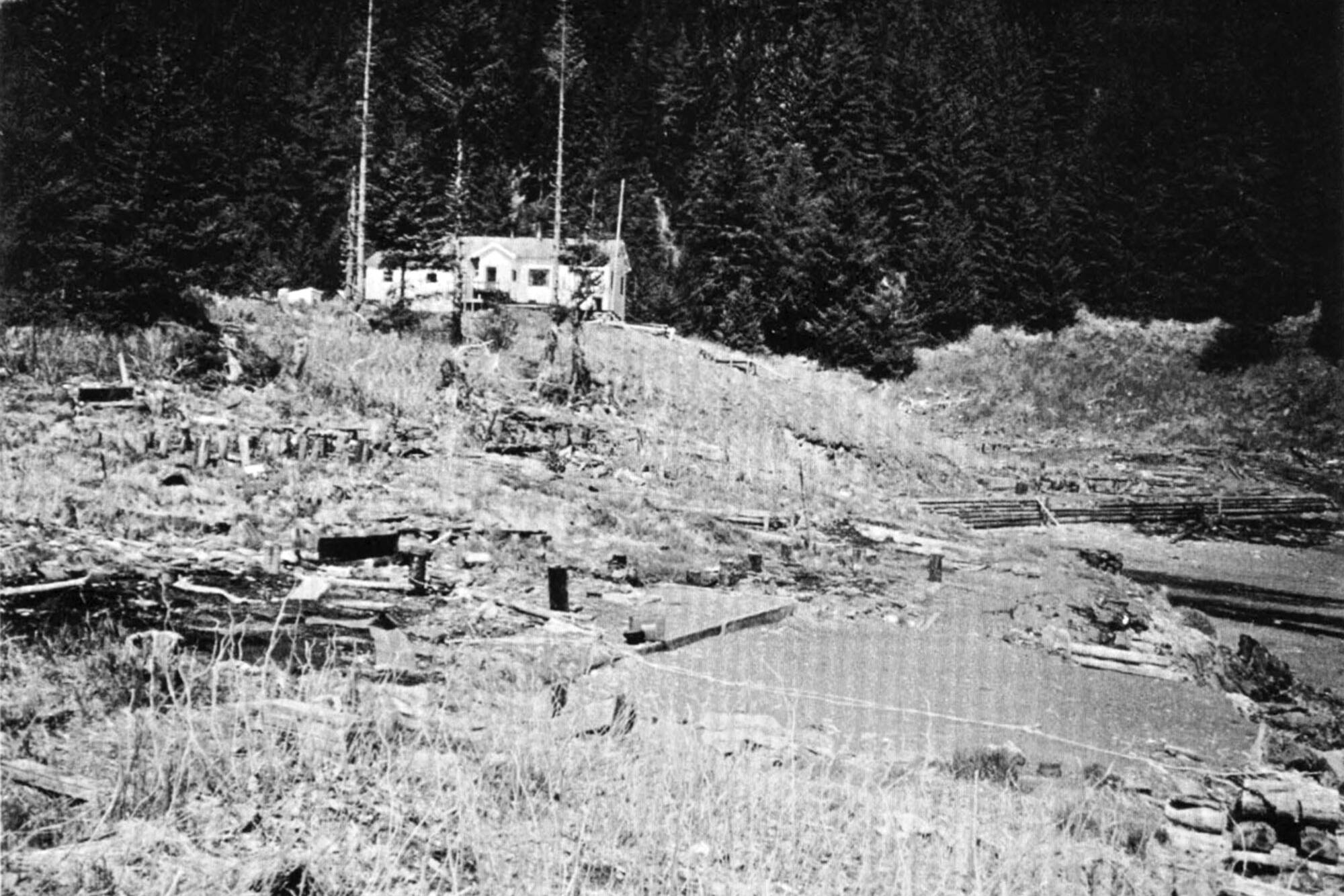 Chenega Bay in 1964 following the great earthquake. A schoolhouse survived the earthquake and tsunami that followed. The tsunami destroyed houses lower than the schoolhouse. (Photo by George Plafker)
