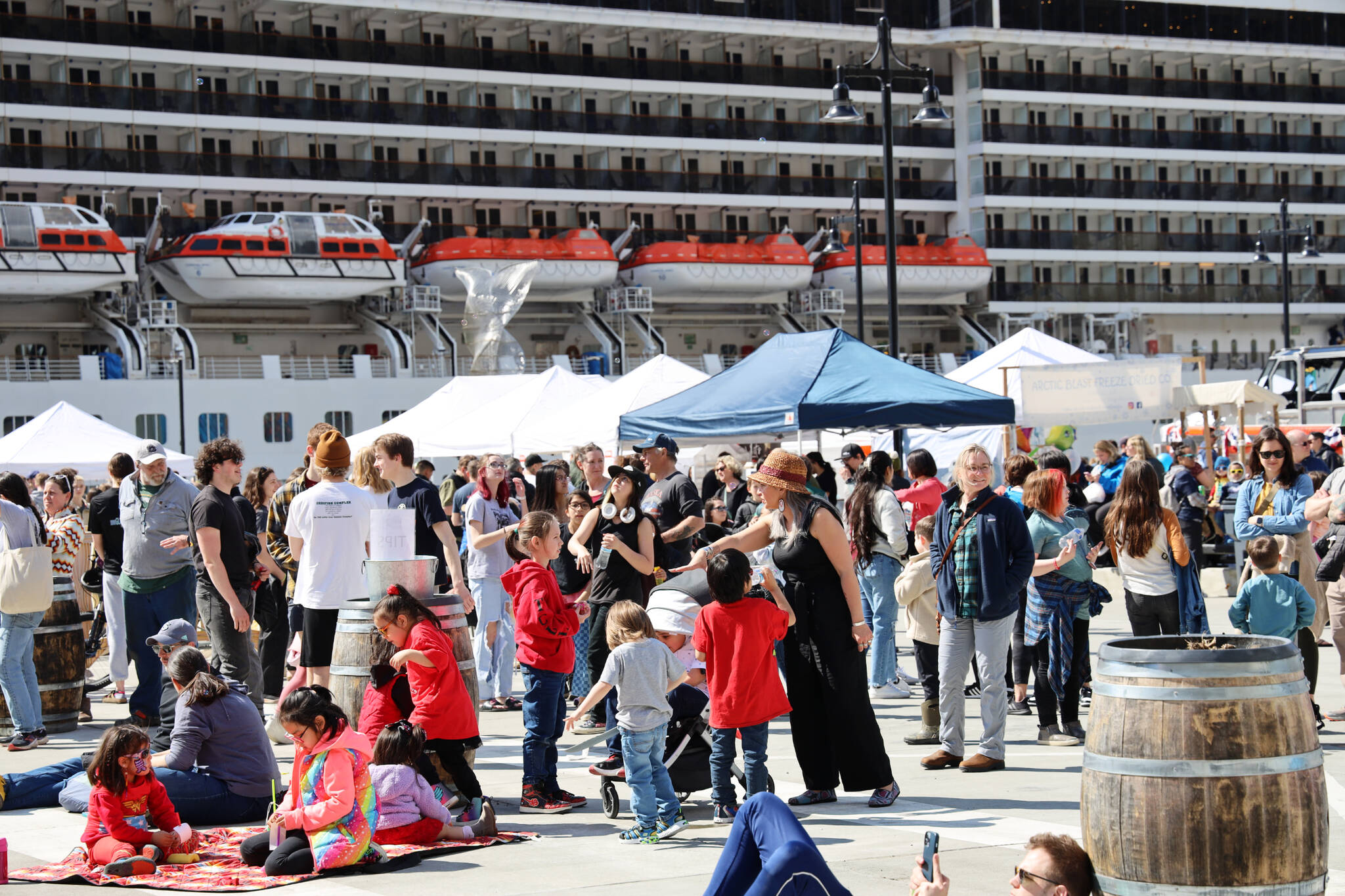 Hundreds walk the waterfront near Elizabeth Peratrovich Plaza during the 2023 Juneau Maritime Festival in early May. City data revealed a total of 627,220 passengers have visited Juneau so far this cruise ship season and large ships in the last three months came in at 99% of their official capacity. (Clarise Larson / Juneau Empire File)