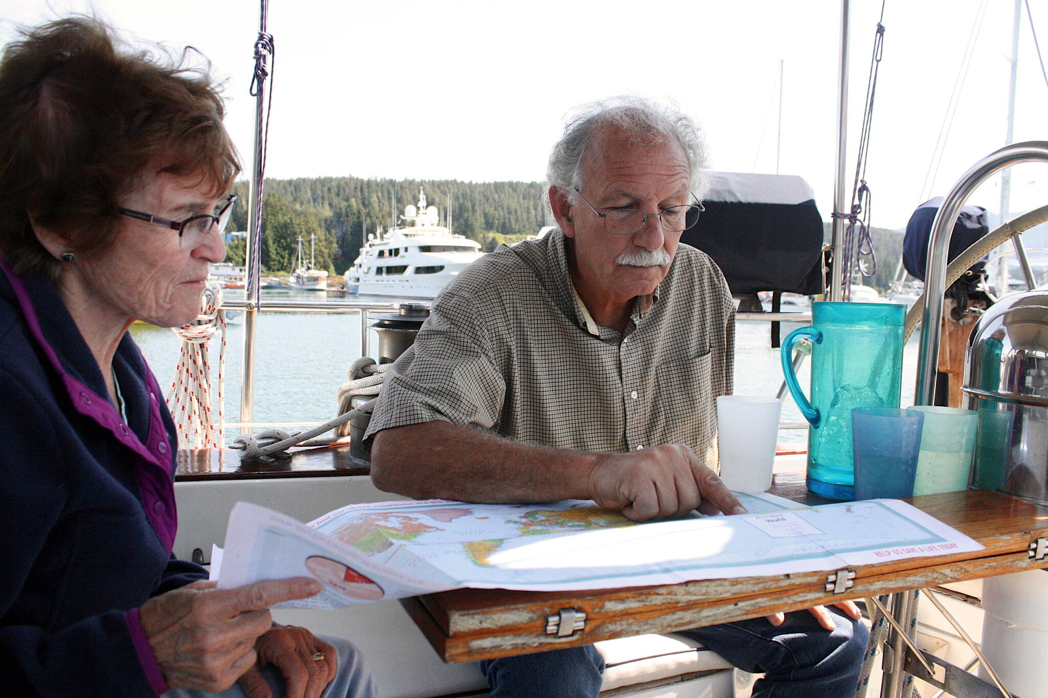 Marjorie Menzi and William “Bill” Heumann discuss their 50,000-nautical-mile circumnavigation of the world aboard their sailboat, Second Wind, on Sunday at Statter Harbor. (Therese Pokorney / Juneau Empire)