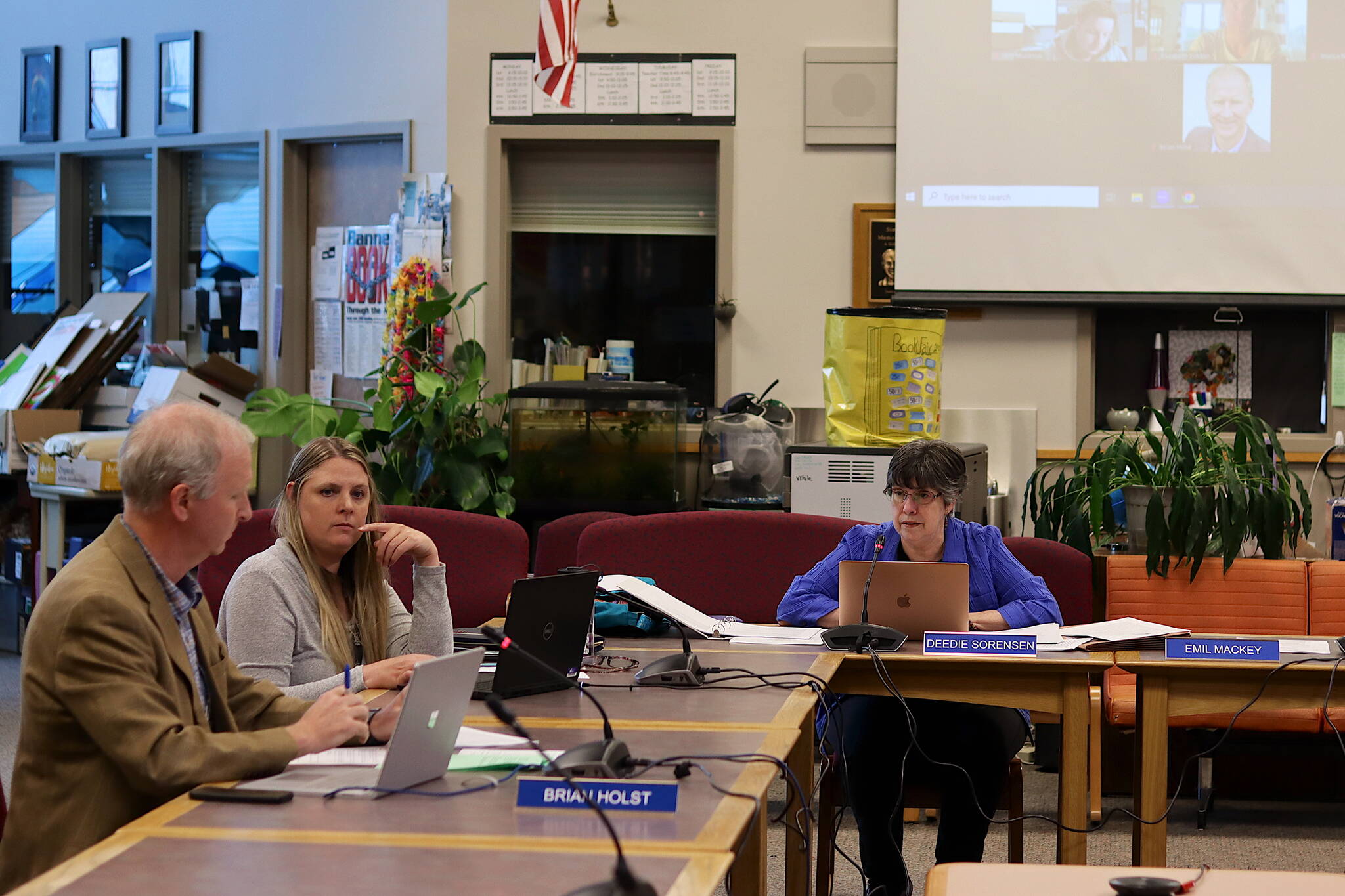 Brian Holst (left) presents details about an upcoming meeting of statewide school board members who plan to discuss possible legal action against the state related to education funding during a Juneau Board of Education meeting Tuesday afternoon at Juneau-Douglas High School: Yadaa.at Kalé. (Mark Sabbatini / Juneau Empire)