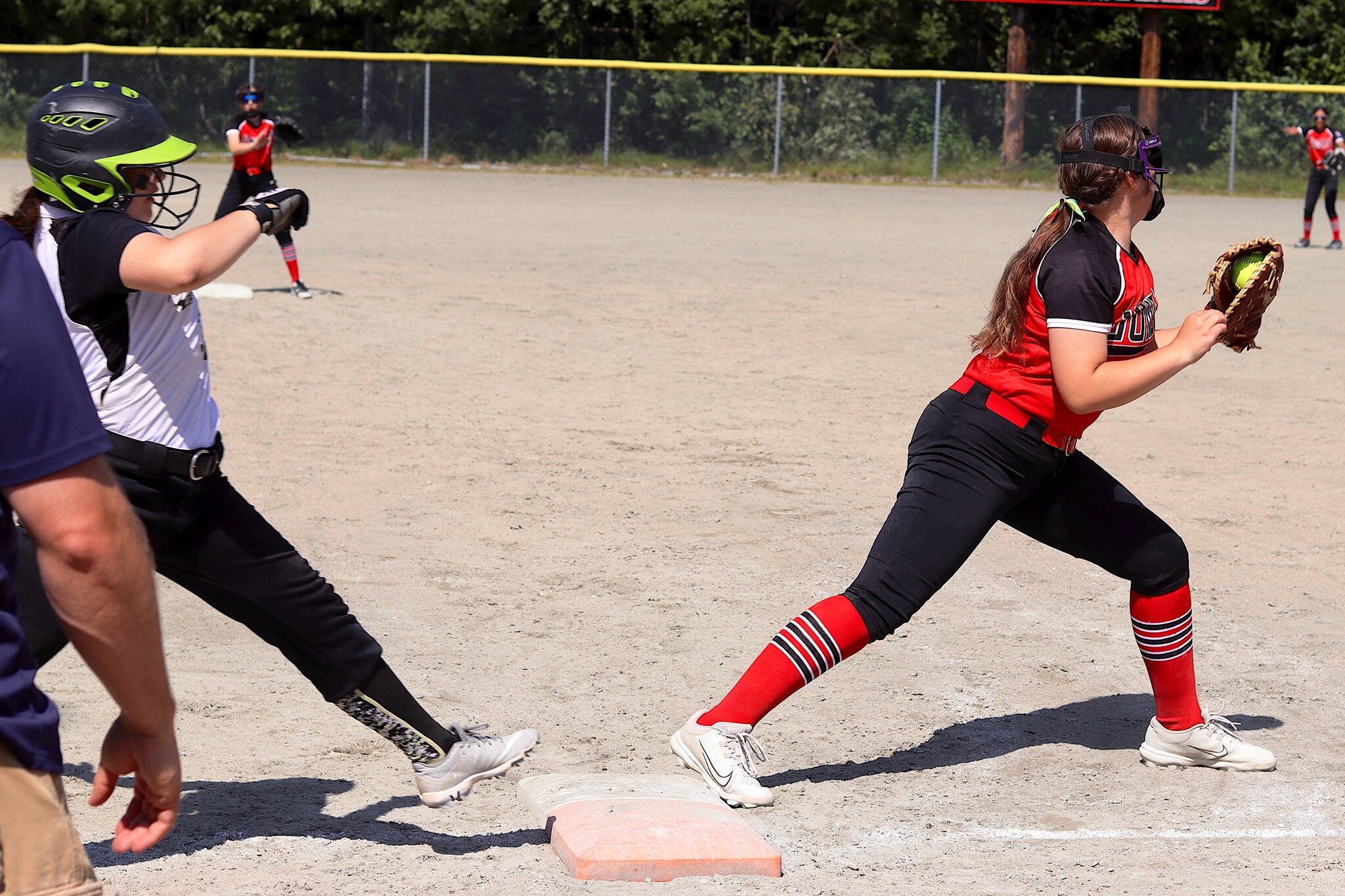 Juneau’s Aurora Lee tags an out at first base to help prevent an attempted comeback by Anchorage’s Abbot-O-Rabbit in the decisive game of the Majors Softball State Tournament on Saturday at Melvin Park. (Mark Sabbatini / Juneau Empire)