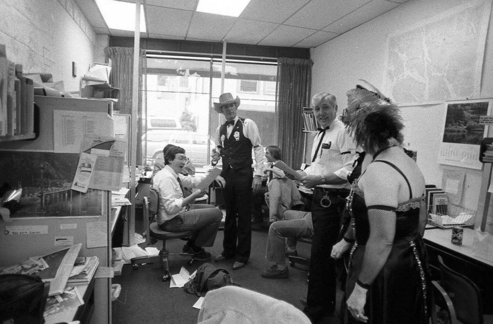 Then-managing editor of the Juneau Empire Carl Sampson (seated left) holds a warrant for his “arrest” by the Juneau Slammer, a fundraiser on June 22, 1984. The Empire was located in the AELP building with its entrance on Second Street during the 1980s. (Photo by Brian Wallace)