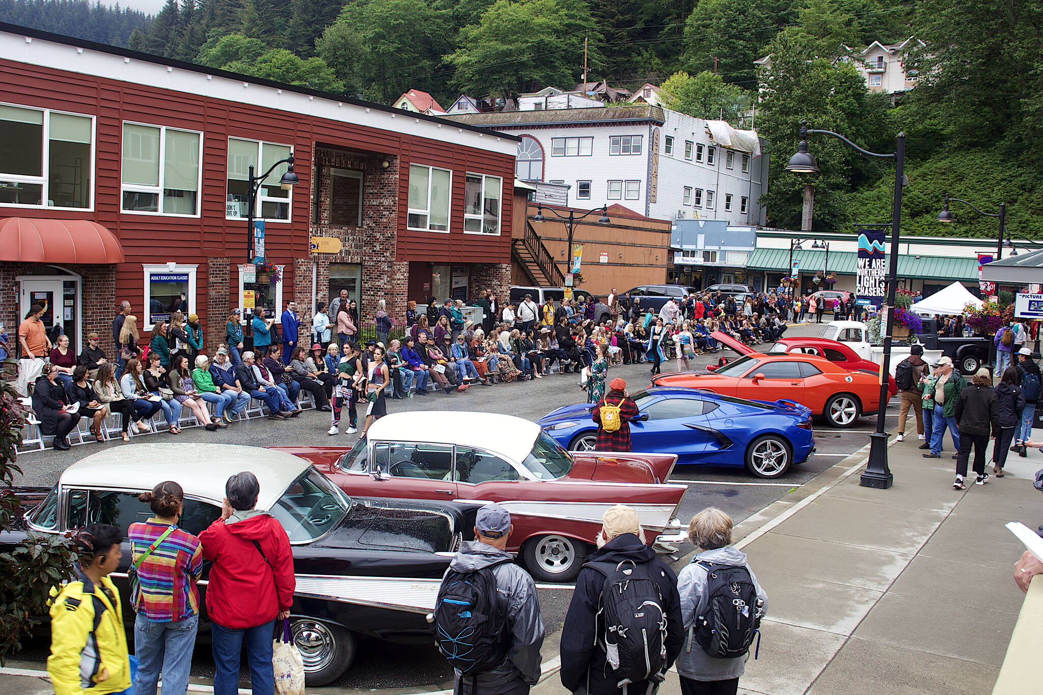 More than 100 residents, tourists and other observers line Ferry Way to watch Alaska Fashion Weeks outdoor runway show in downtown Juneau on Saturday. (Mark Sabbatini / Juneau Empire)