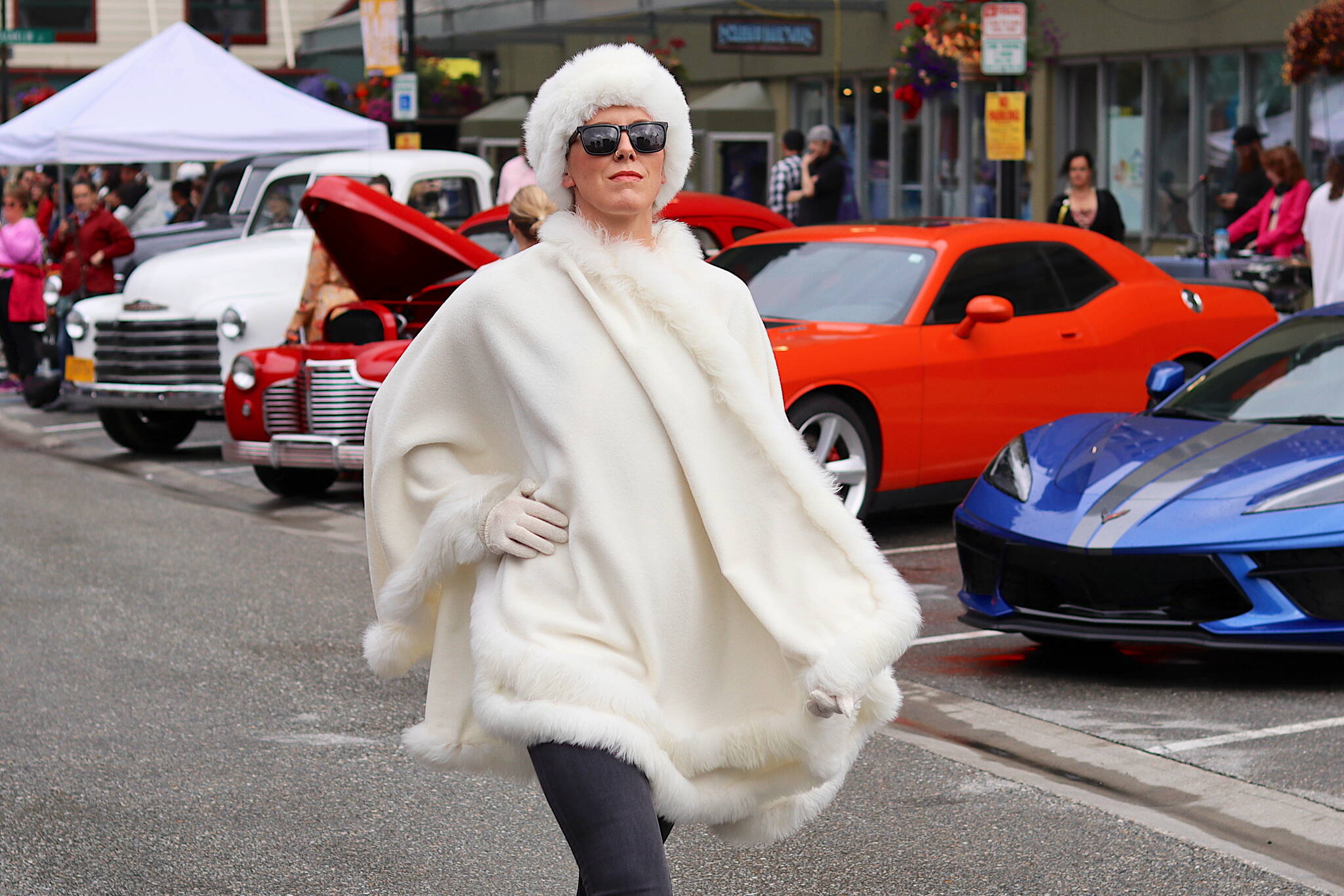 Jackie Kragel wears a fur-trimmed alpaca cape during Alaska Fashion Week’s outdoor runway show in downtown Juneau on Saturday. Kragel, a Palmer resident appearing in her first fashion show as a model, wore outfits by five different designers during the two-hour show, plus jewelry she made at her own studio. (Mark Sabbatini / Juneau Empire)
