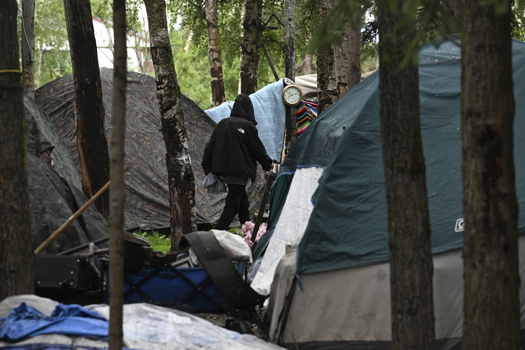 Tents fill a homeless camp near Davis Park in Mountain View on July 3 in Anchorage. An unfunded proposal by Anchorage’s mayor to pay for plane tickets to warmer climates for homeless people who would otherwise be forced to winter outside in the bitter cold has caused a stir in Alaska’s biggest city. If the program moves forward, people can choose to relocate to the Lower 48 or somewhere else in Alaska where it might be warmer or where they have relatives. (Bill Roth / AP)