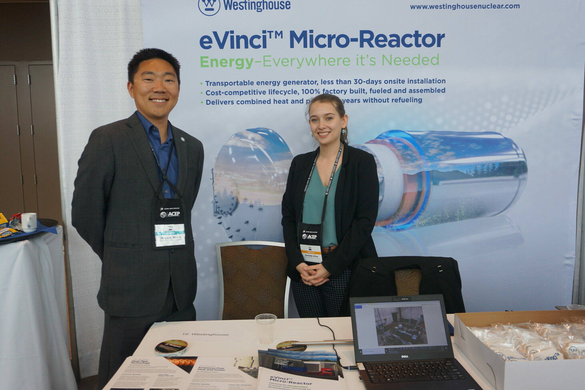 Michael Valore, senior director of advanced reactors energy systems, and Danielle Kline, test engineer, stand at a booth promoting Westinghouse’s microreactor technology at an Anchorage conference in 2022. Westinghouse plans to bid on a contract to build a nuclear microreactor at Eielson Air Force Base. (Photo by Yereth Rosen/Alaska Beacon)