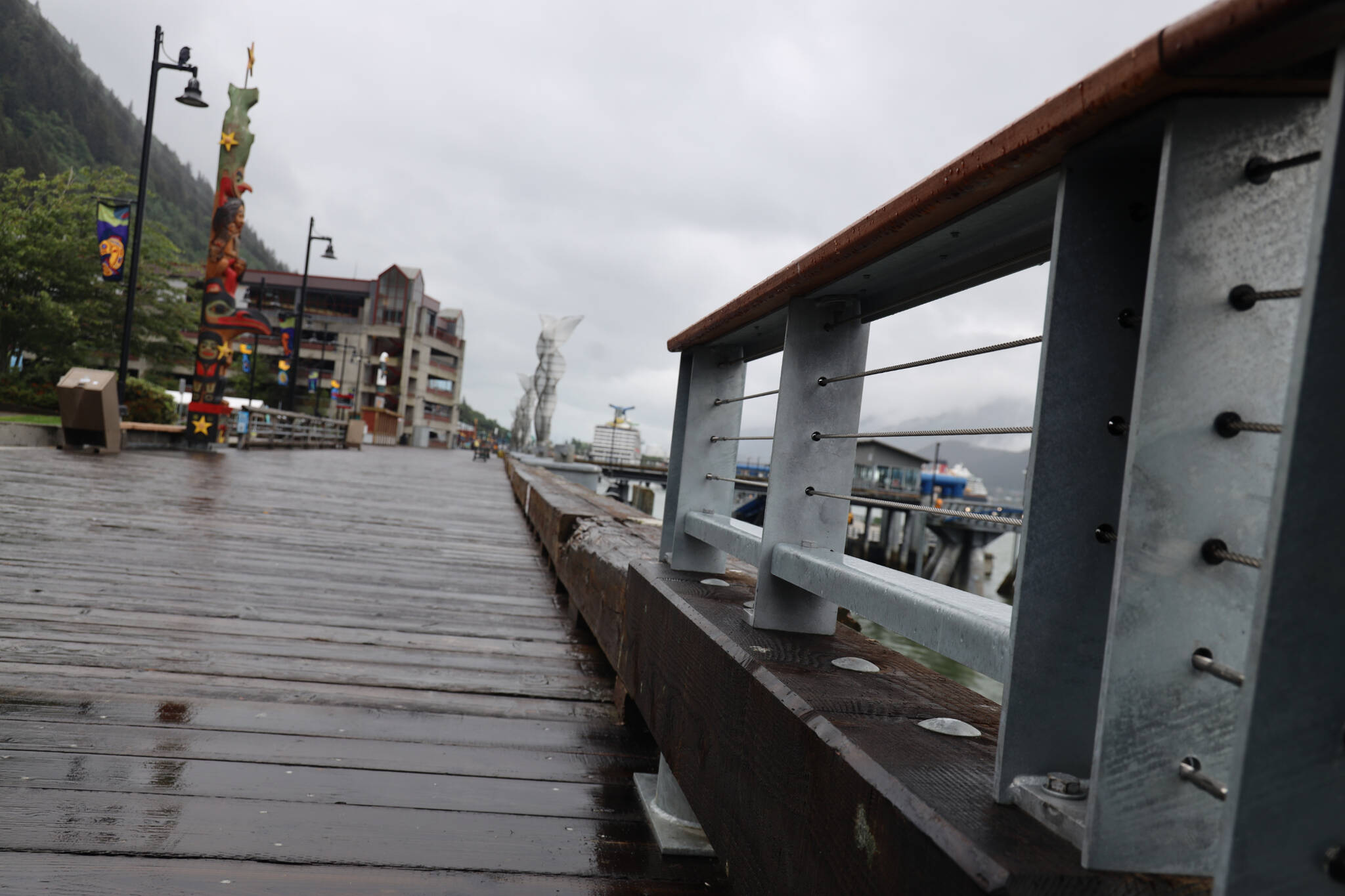 A section of safety rail ends into a bull rail along the downtown cruise ship docks in July. (Clarise Larson / Juneau Empire File)