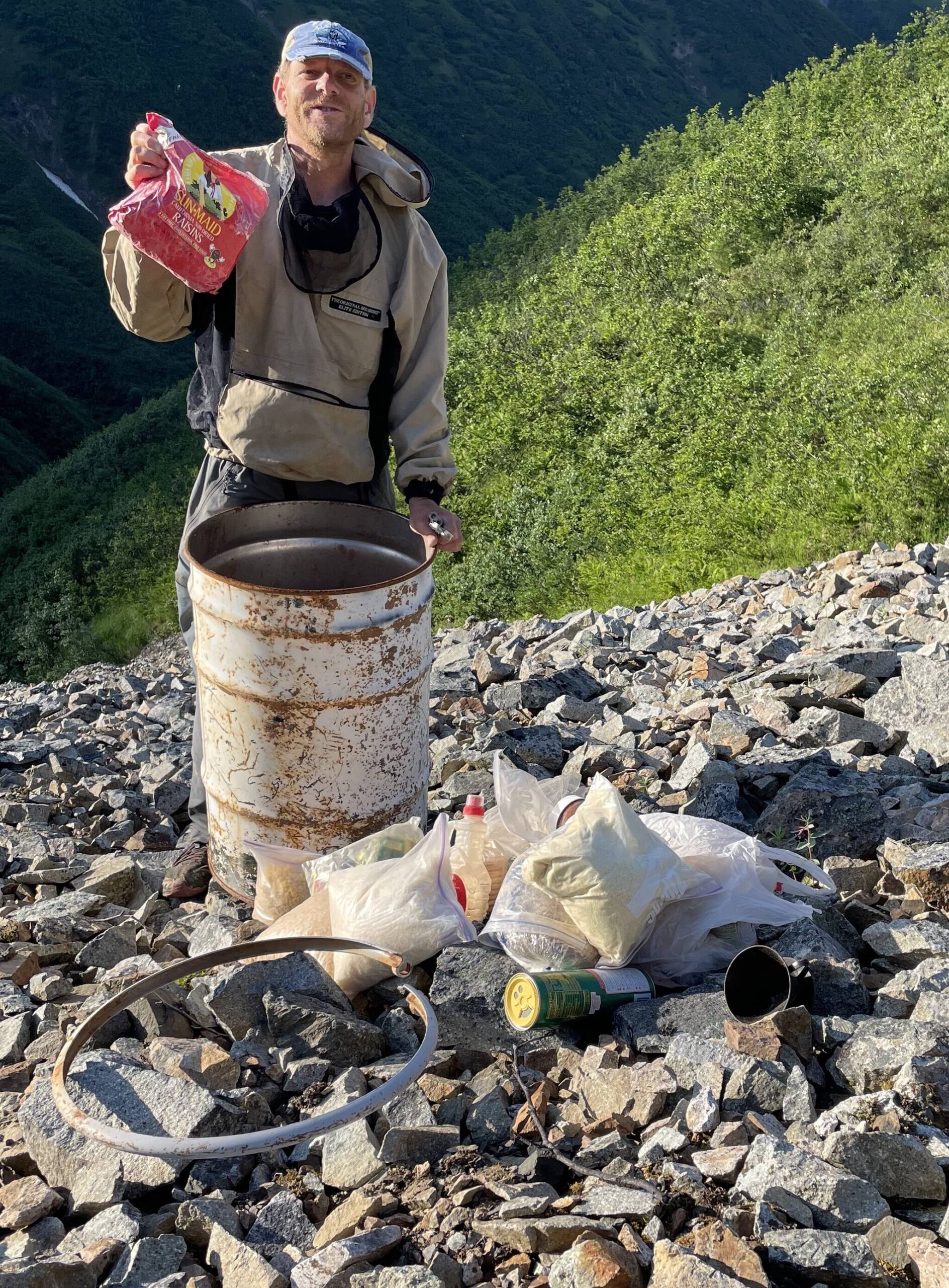Glaciologist Martin Truffer holds raisins that had been preserved for more than 20 years in a barrel cache scientists left on Fireweed rock glacier near McCarthy. (Photo by Ned Rozell)