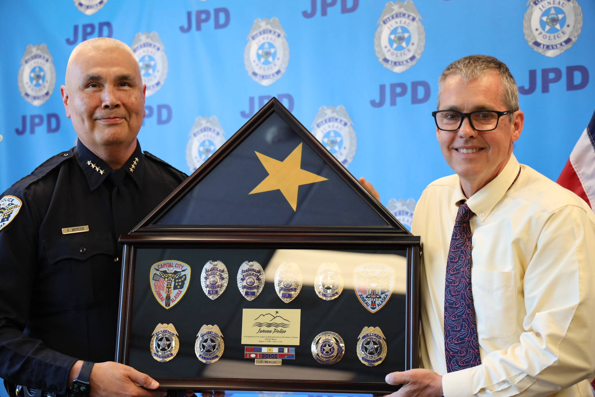 Retiring Juneau Chief of Police Ed Mercer (left) and City Manager Rorie Watt (right) smile for a photo during Mercer’s retirement ceremony Friday afternoon at the Juneau Police Department station. (Clarise Larson / Juneau Empire)