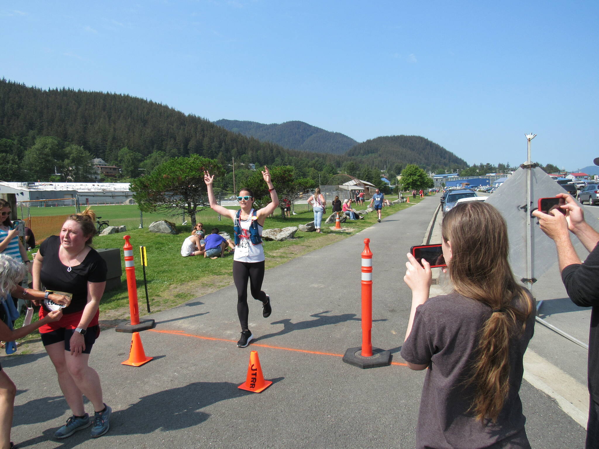 Kristin Campbell, of Deer Park, Ohio, is photographed by observers at the finish line of the Juneau Half Marathon on Saturday at Savikko Park. (Photo courtesy of Juneau Trail and Road Runners)
