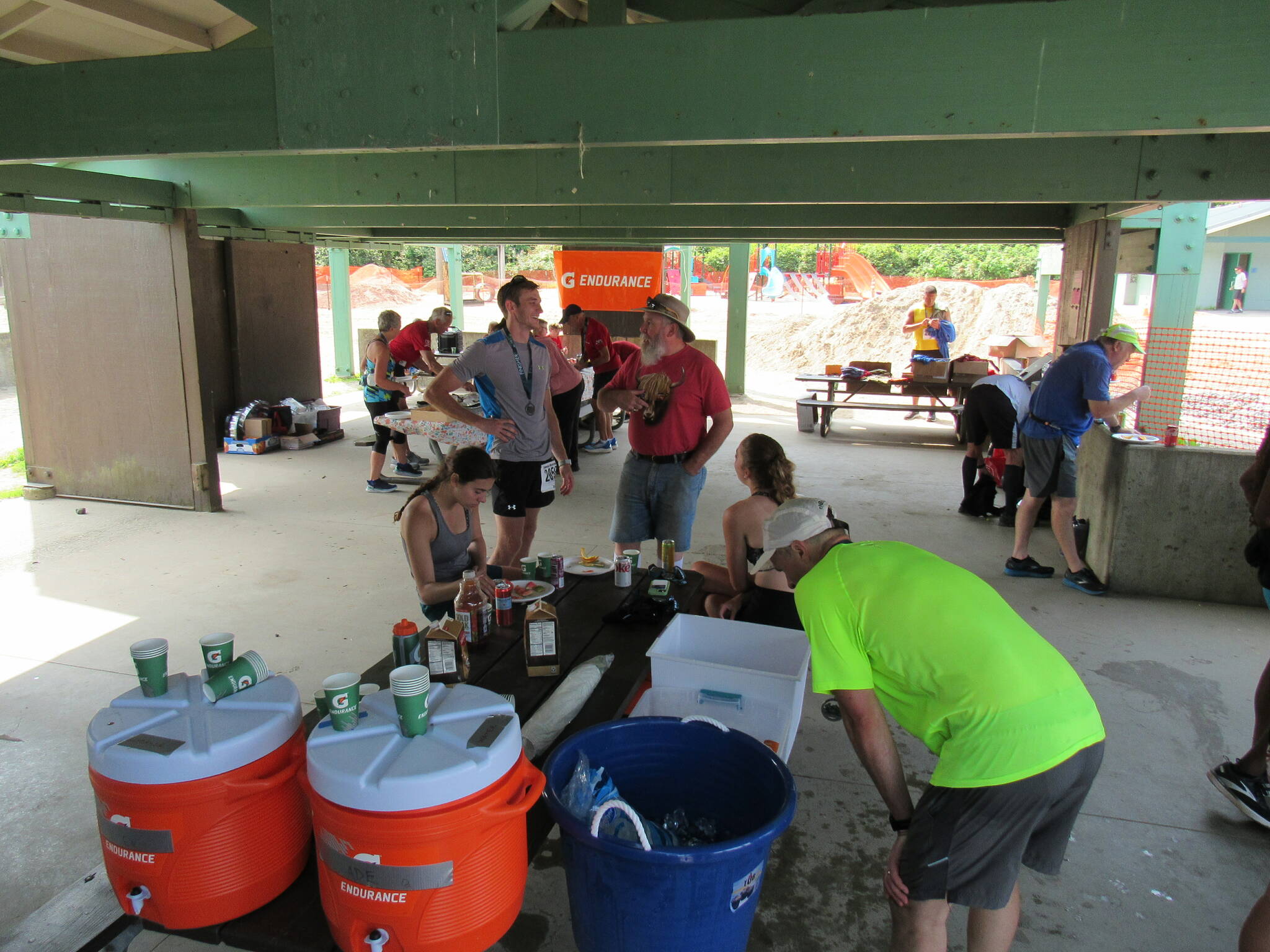 Participants in the Juneau Marathon and Half Marathon take shelter from the sun as they recharge with food and drinks at Savikko Park on Saturday. (Photo courtesy of Juneau Trail and Road Runners)