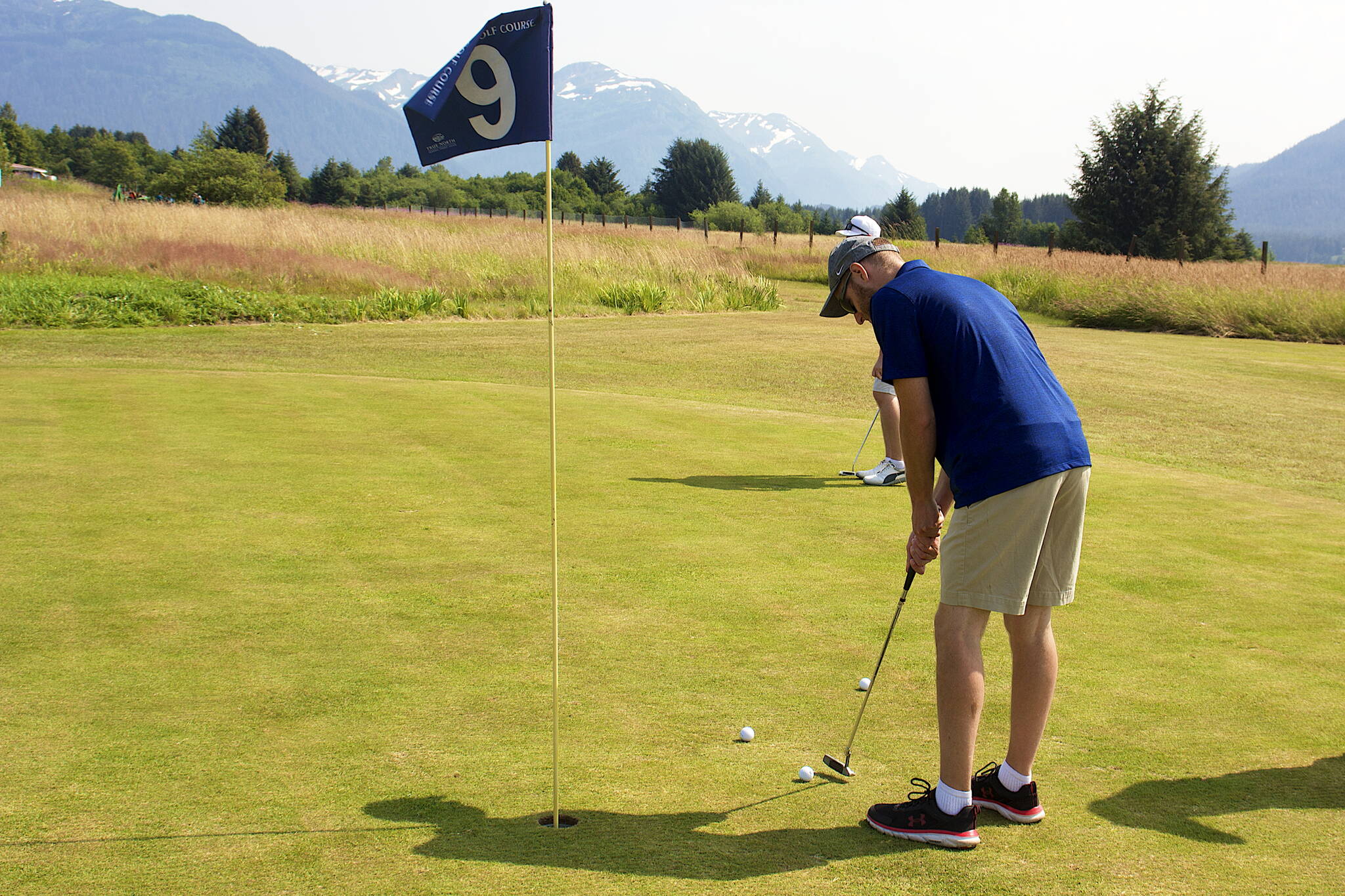 Matt Schienke putts on the ninth hole during the Annual Greater Juneau Chamber of Commerce Golf Classic on Saturday at the Mendenhall Golf Course. (Mark Sabbatini / Juneau Empire)