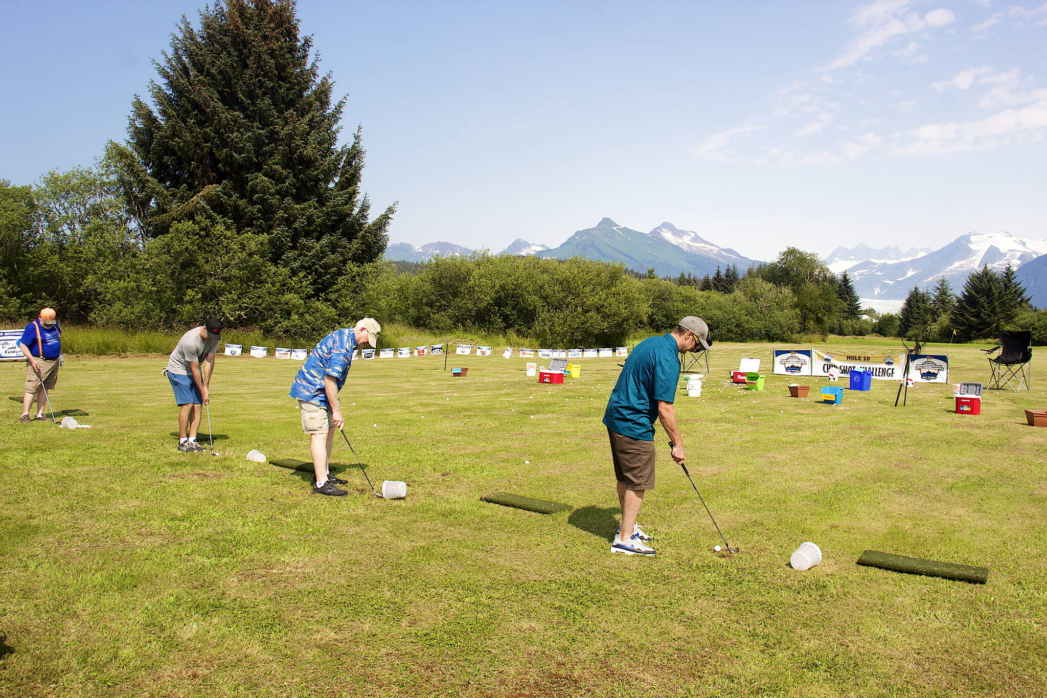Golfers test their skills at the “chip shot challenge” during the Annual Greater Juneau Chamber of Commerce Golf Classic on Saturday at the Mendenhall Golf Course. (Mark Sabbatini / Juneau Empire)