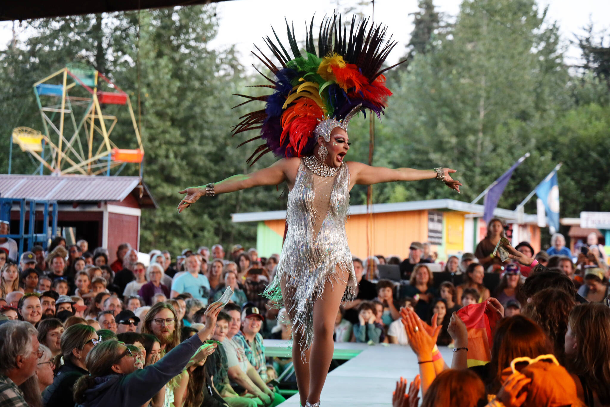 Juneau Drag performer and event emcee Gigi Monroe struts the runway in front of hundreds gathered at the main stage of the Southeast Alaska State Fair in Haines on Friday evening for the performance group’s debut show at the fair. (Clarise Larson / Juneau Empire)