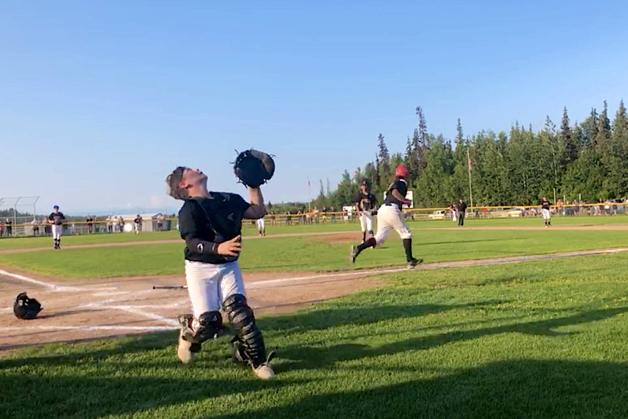 Juneau catcher Isaac Kirsch looks to catch a pop-up foul against Dimond West in the deciding fifth game of the Alaska Little League Majors Baseball State Tournament in Anchorage. (Screenshot from Gastineau Channel Little League video of game)