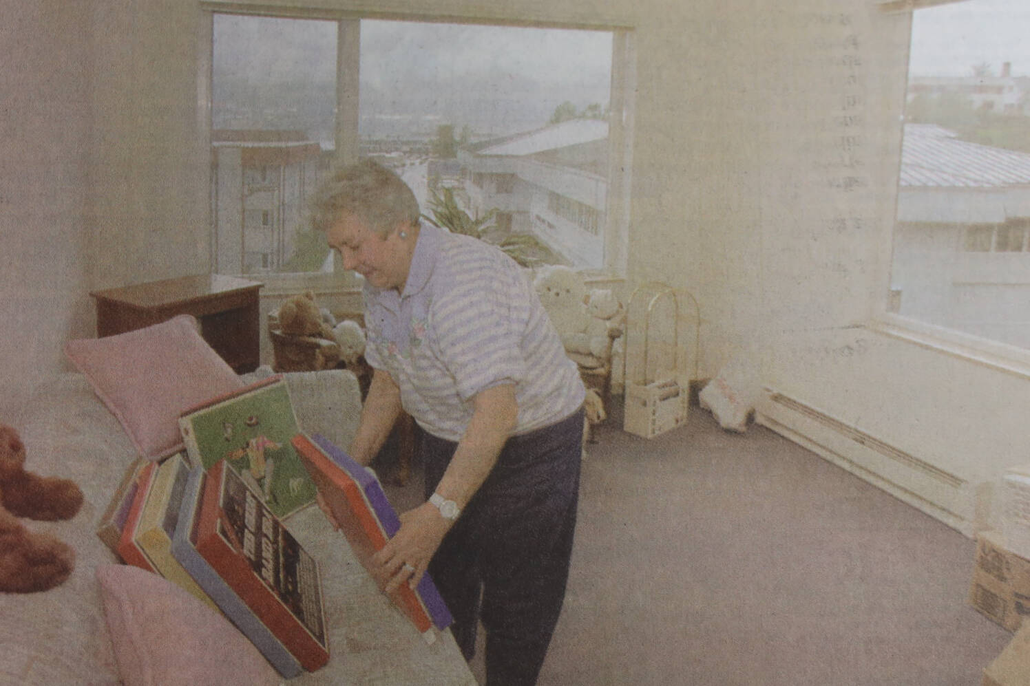 Marie Darlin unpacks her record collection as she moves into her fifth-floor apartment in Fireweed Place. (Brian Wallace / Juneau Empire Archives)