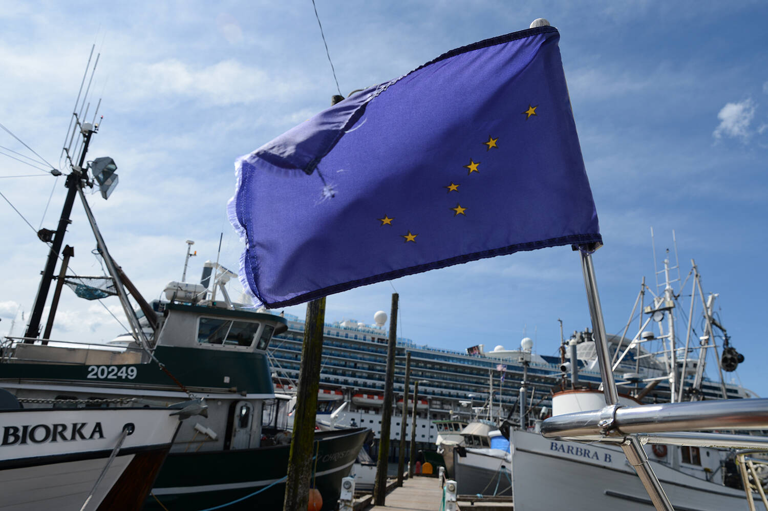The Alaska flag flies from the bow of a boat in one of Ketchikan’s small-boat harbors on July 24. (Photo by James Brooks/Alaska Beacon)