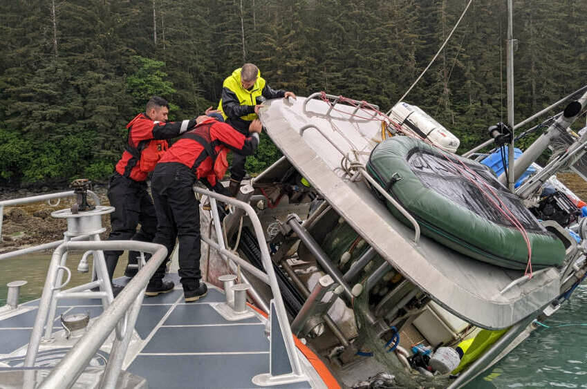 U.S. Coast Guard personnel conducts a rescue of a man aboard a commercial fishing vessel that began taking on water in Gastineau Channel Tuesday morning. (Courtesy / Coast Guard Sector Southeast Alaska)