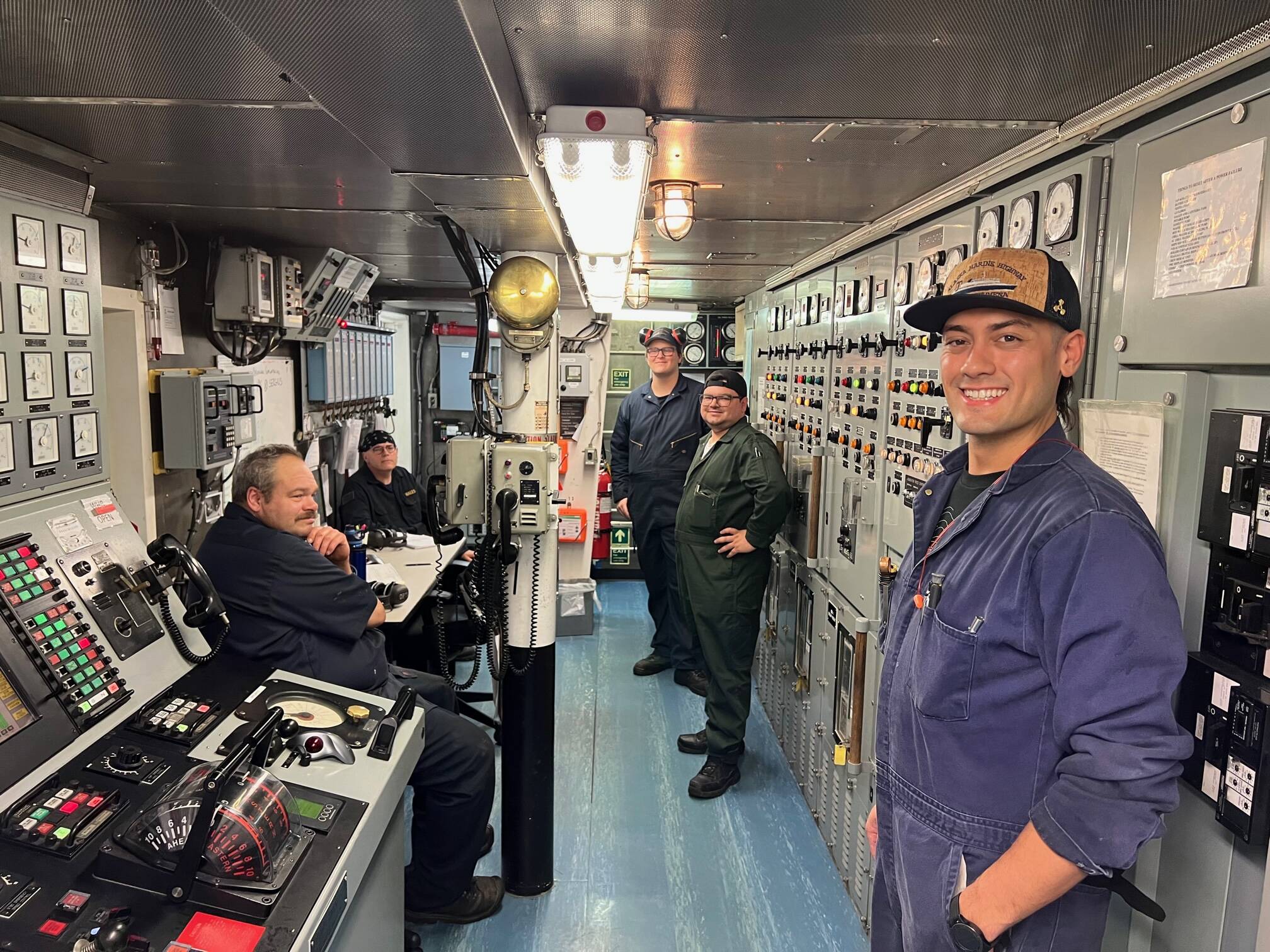 Second Engineer Tanner Greimann and other members of the engine department on board Columbia take a break while the ferry unloads and reloads in Wrangell in mid-July. From left to right: Mike Ladwig, wiper; Evan Hales, oiler; Robert McDougal, cadet; and Sergio Ortiz, third engineer. (Meredith Jordan / Juneau Empire)