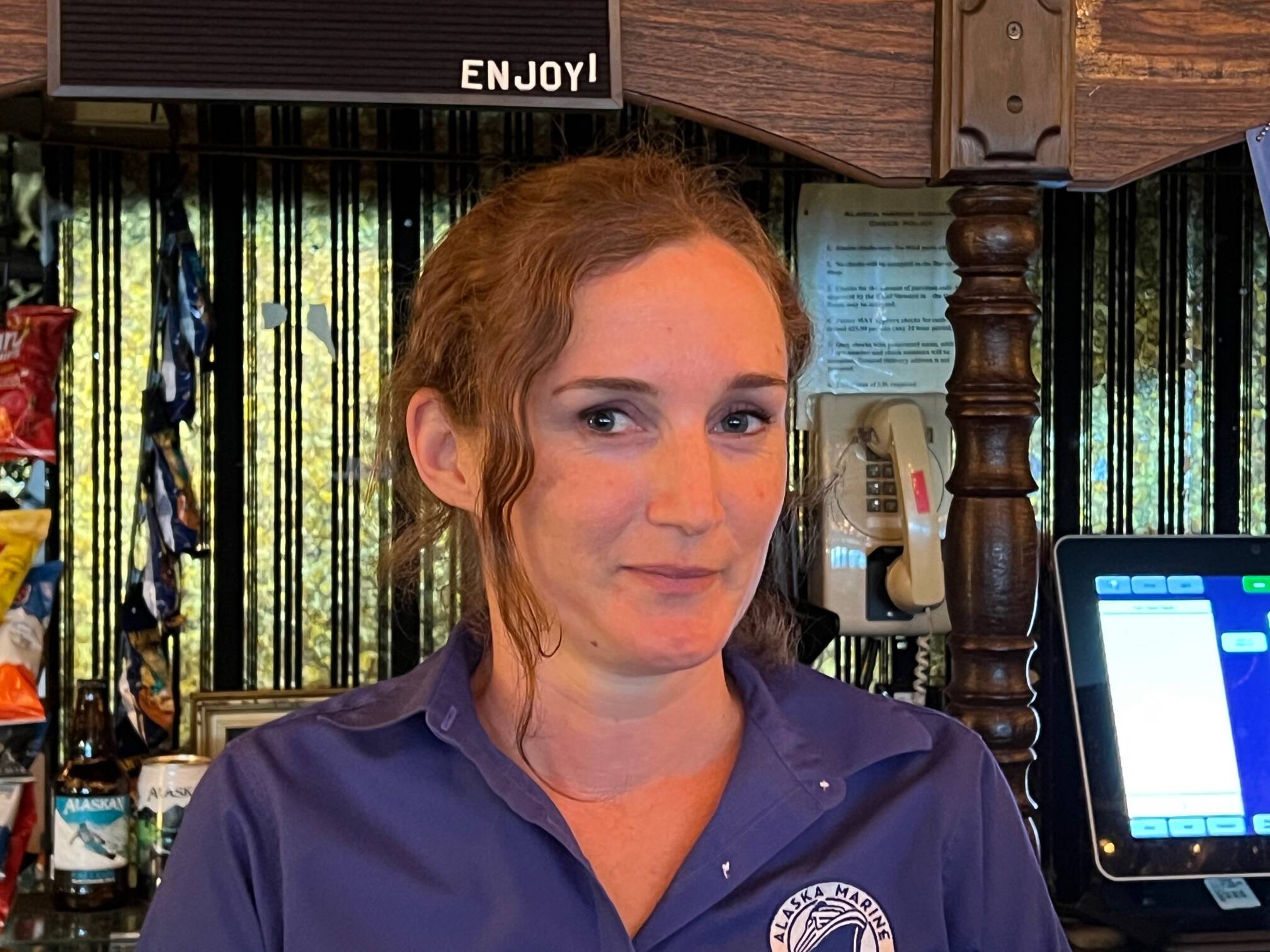 Tending bar is just one of the jobs Amber Geil does as a steward on the Columbia. She also rings up customers in the dining room and cleans staterooms. “We all take on multiple jobs,” she said. (Meredith Jordan / Juneau Empire)