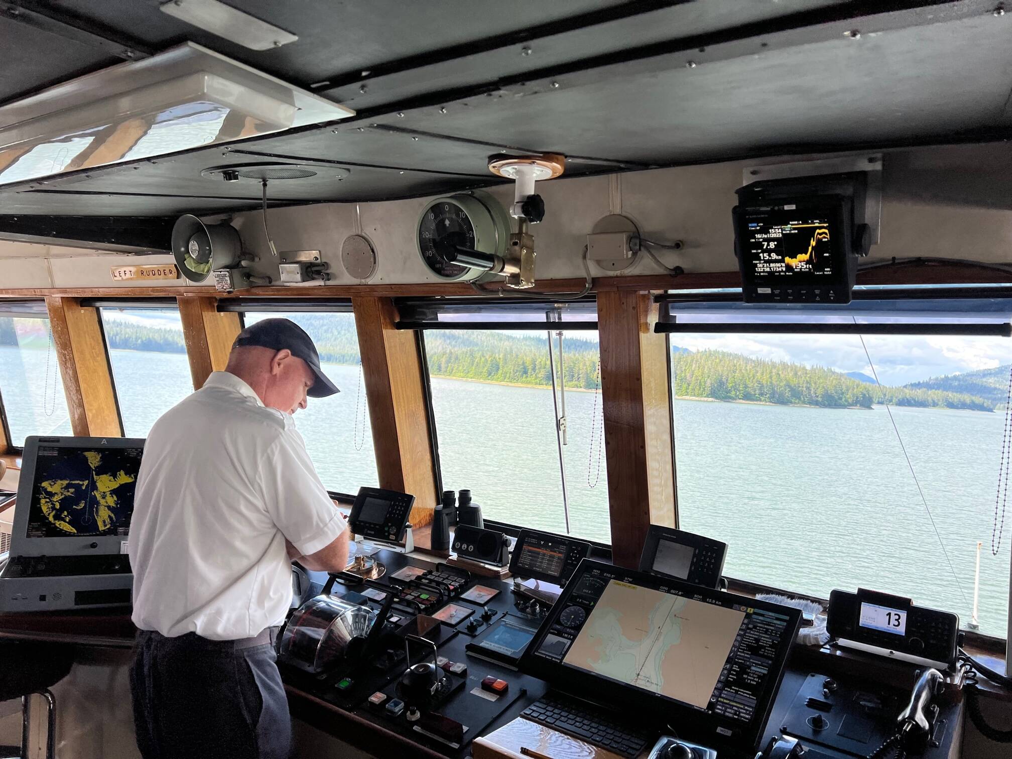 Capt. Dave Turner, who has been with the Alaska Marine Highway System for 14 years, scans some of the equipment on the Columbia. He makes a point of being approachable by crew, but said in the end, “it’s my license.” (Meredith Jordan / Juneau Empire)
