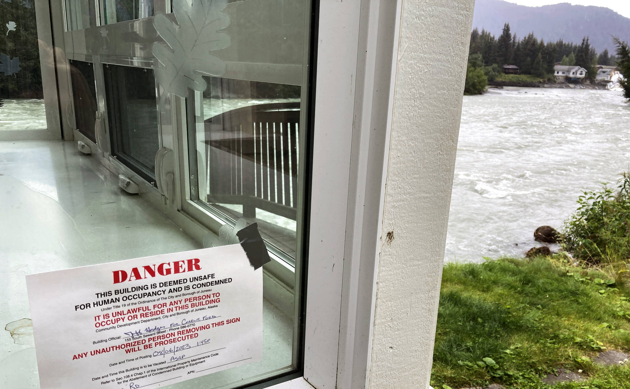 A sign marks a house along the Mendenhall River that is condemned following a glacial dam outburst Saturday that resulted in weekend flooding along the river. (AP Photo/Becky Bohrer)