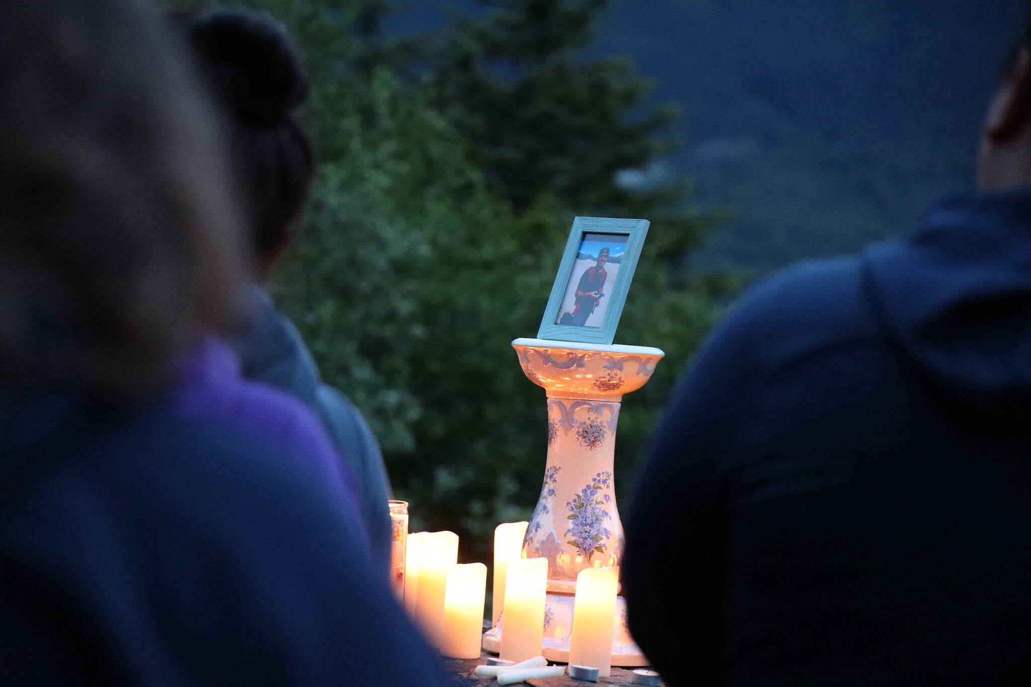 People attend a candlelit vigil that was held at the Mendenhall Glacier Visitor Center to honor Paul Rodriguez Jr., pictured, who drowned while kayaking on Mendenhall Lake in July. The search for his body has been called off following the record flooding from Suicide Basin during the weekend, officials say. (Clarise Larson / Juneau Empire File)