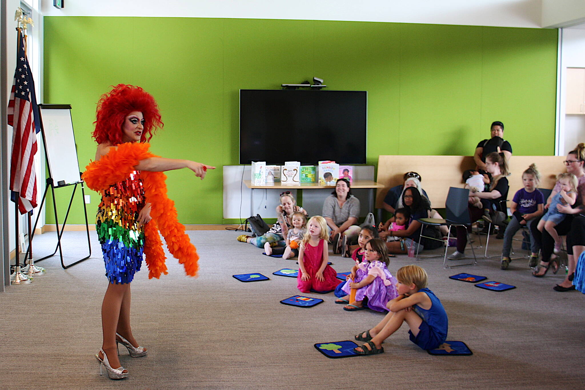 Drag queen Gigi Monroe performs an opening song during a Drag Storytime at the Mendenhall Valley Public Library on Saturday, Aug. 5. (Mark Sabbatini / Juneau Empire)