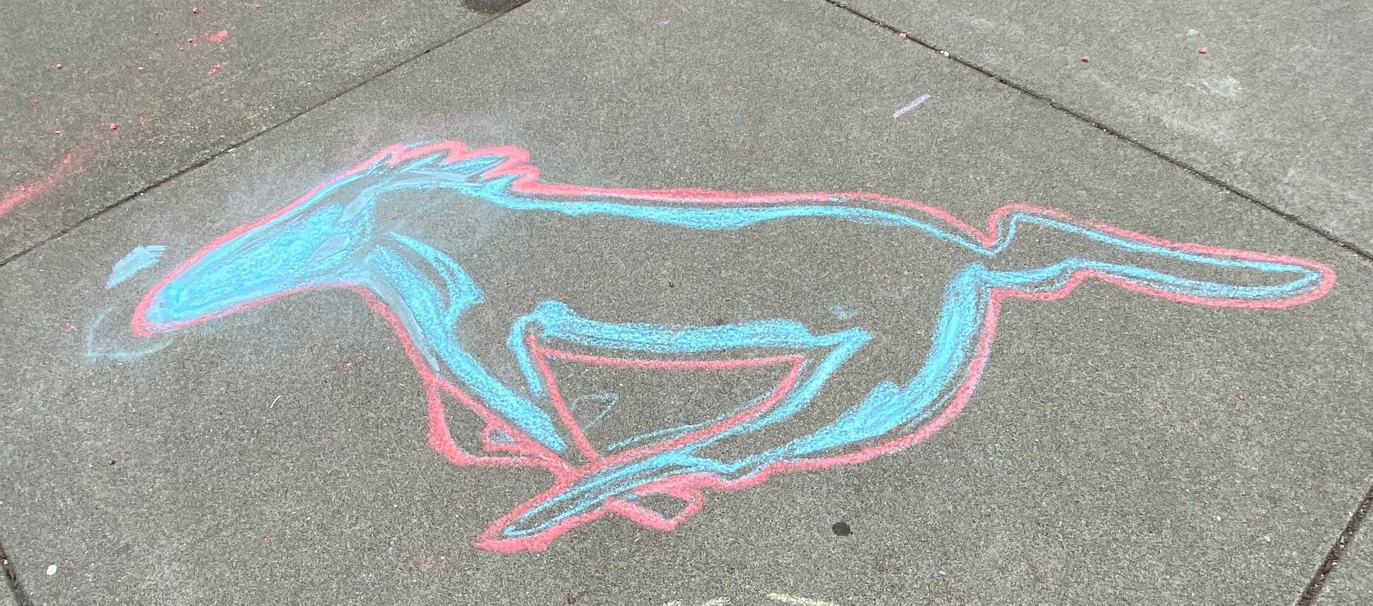 Racing along the waterfront… chalk drawing at the Goldbelt Tram on Aug. 3. (Photo by Denise Carroll)