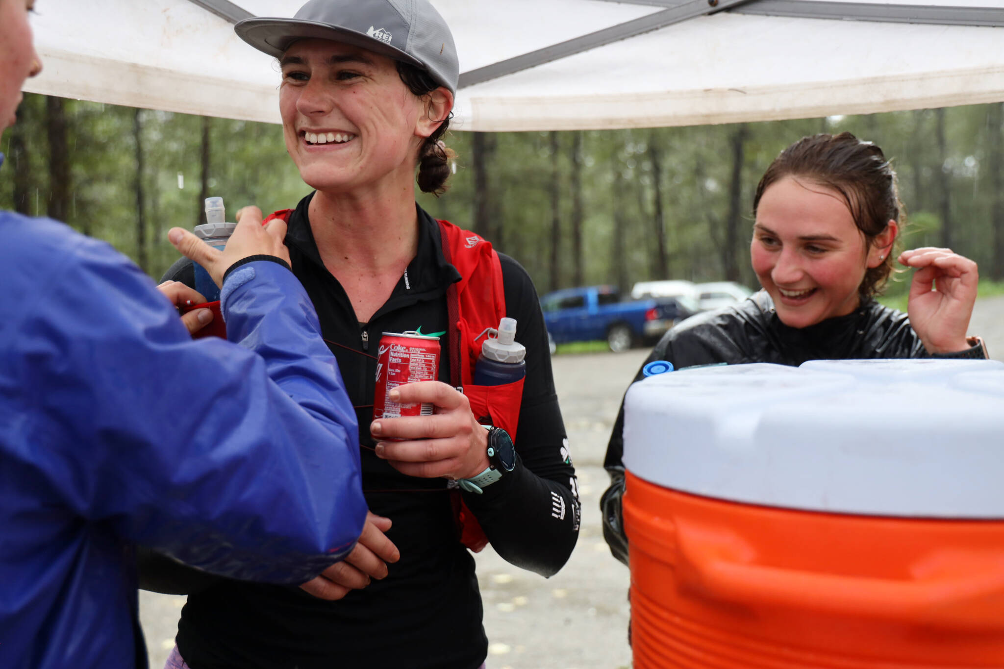 Lauren Tanel smiles as she refuels at an aid station before starting the next leg of the Nifty Fifty 50K race Saturday afternoon. Tanel was the second female finisher of the race with a time of six hours, one minute and 32 seconds.