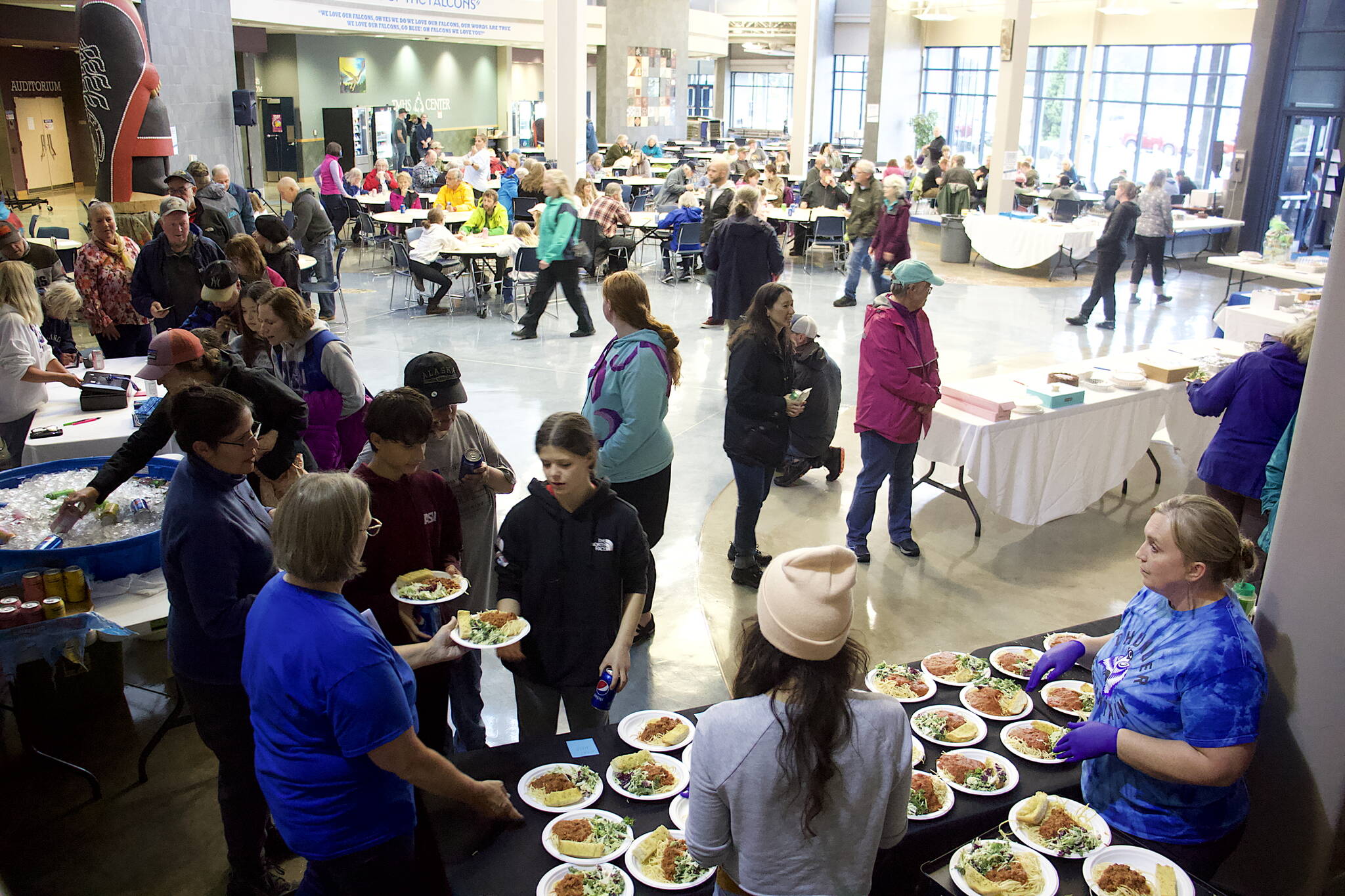 Hundreds of people participate in a spaghetti dinner and dessert auction Saturday night at Thunder Mountain High School to raise funds for residents affected by record flooding of the Mendenhall River earlier this month. More than $20,000 was raised during the event. (Mark Sabbatini / Juneau Empire)