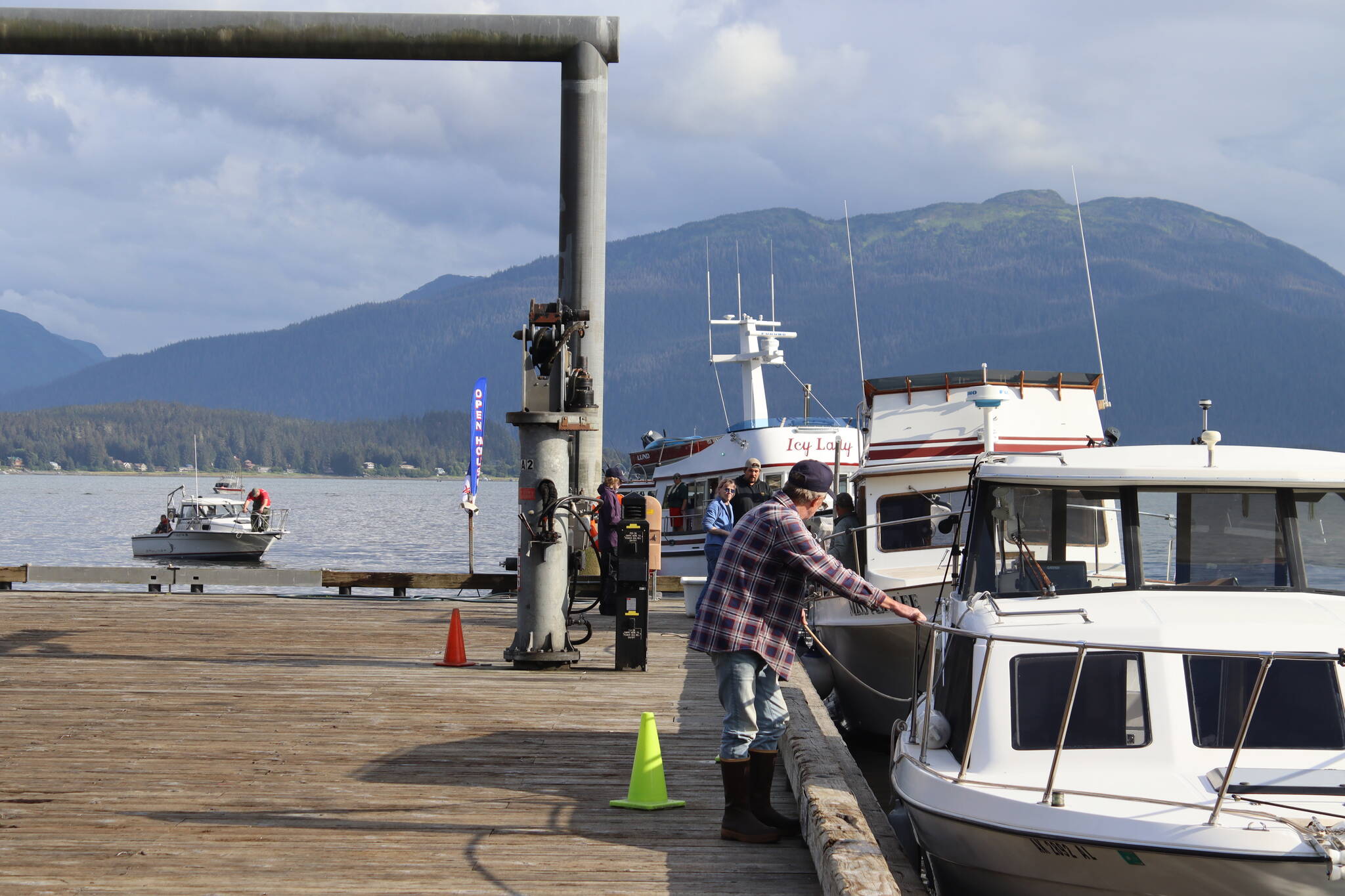 Boats and people line up to drop off and weigh their catch at the Auke Nu Cove station on Sunday evening as the 77th Annual Golden North Salmon Derby draws to a close. (Meredith Jordan / Juneau Empire)
