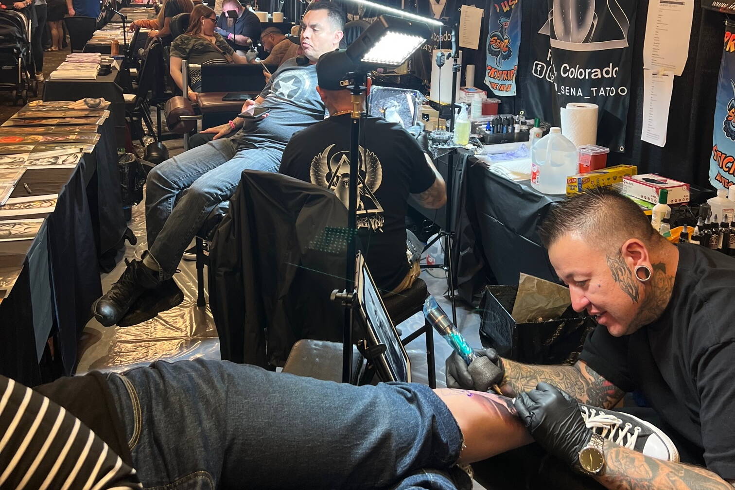 Tattoo artists make their marks on attendees at an Ink Masters Tattoo Show in Colorado. (Courtesy of Ink Masters)