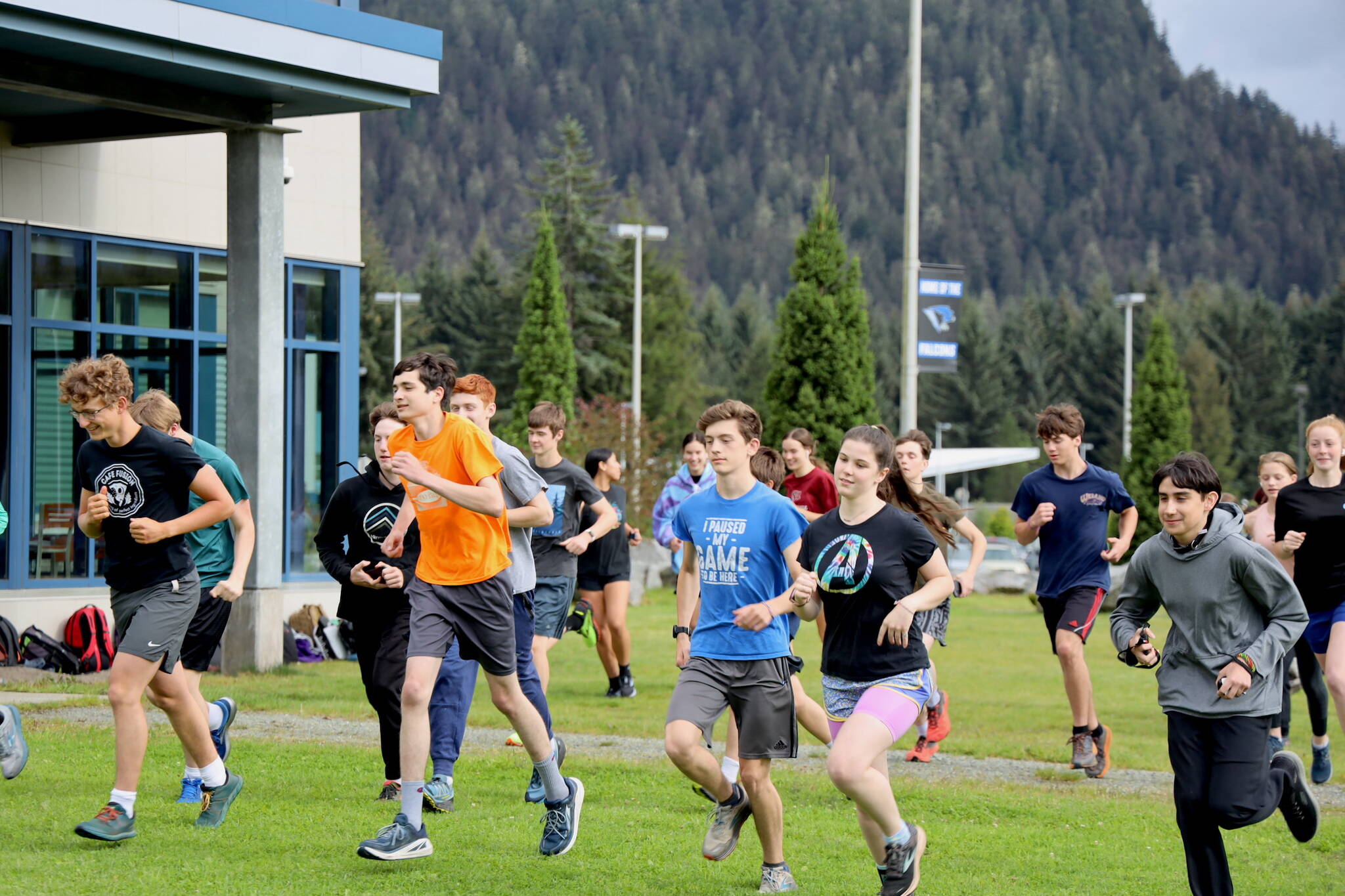 The Thunder Mountain High School cross-country team begin their workout during practice outside of the high school Thursday evening. (Clarise Larson / Juneau Empire)