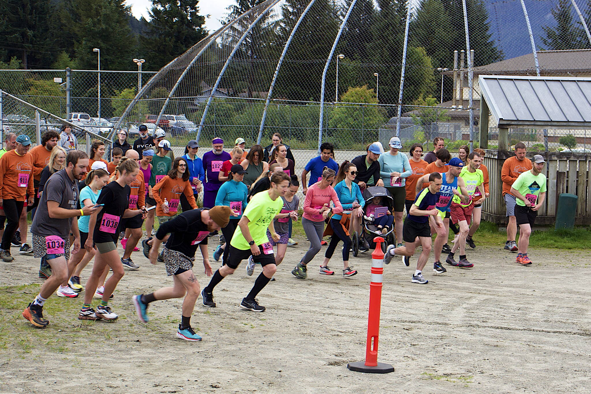 Dozens of runners start the 5K course during the 32nd Annual Beat the Odds: A Race Against Cancer that started and ended at Kax̱dig̱oowu Héen Elementary School on Saturday morning. A total of 312 people signed up for the run and a separate two-mile walking event, with an event official estimating about 25% took part in the 5K. (Mark Sabbatini / Juneau Empire)