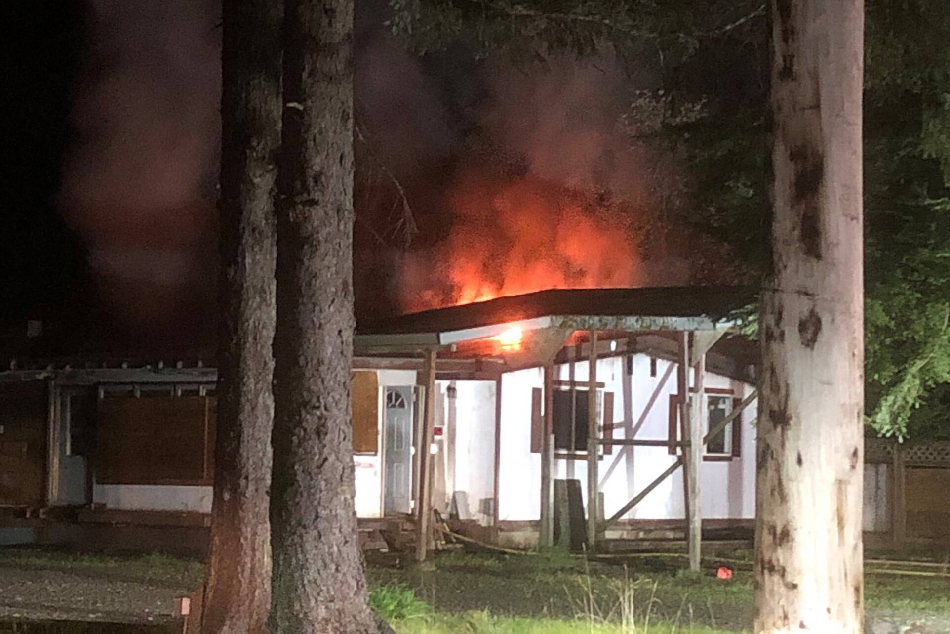 Fire blazes from an abandoned home in the Mendenhall Valley on Tuesday morning. Capital City Fire/Rescue officials are investigating the fire as a possible arson. (Courtesy of Capital City Fire/Rescue)