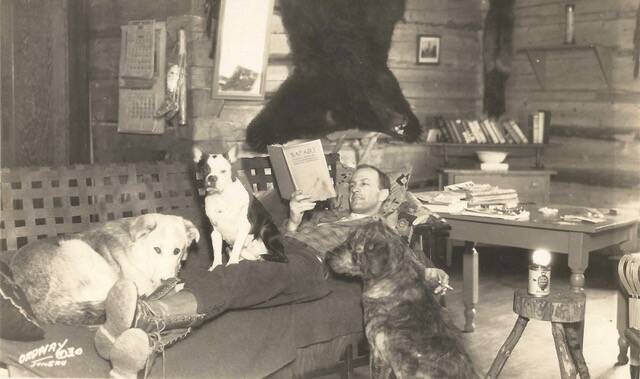 Leigh Hackley “Hack” Smith reads on a couch at the Taku Lodge in this undated photo. (Courtesy of Ken and Mic Ward)