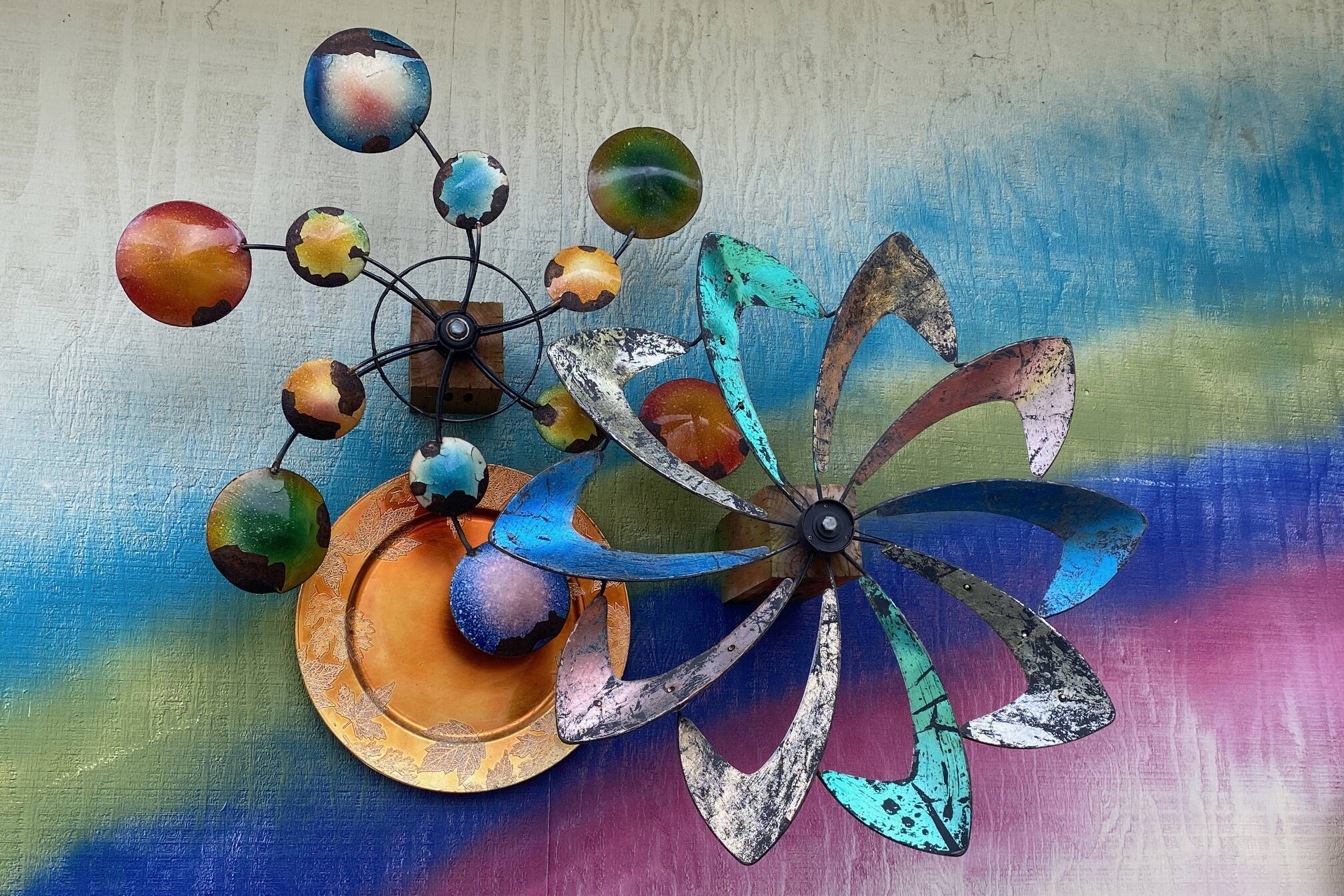 Spheres and spinners ride a rainbow on a downtown wall on Aug. 13. (Photo by Denise Carroll)