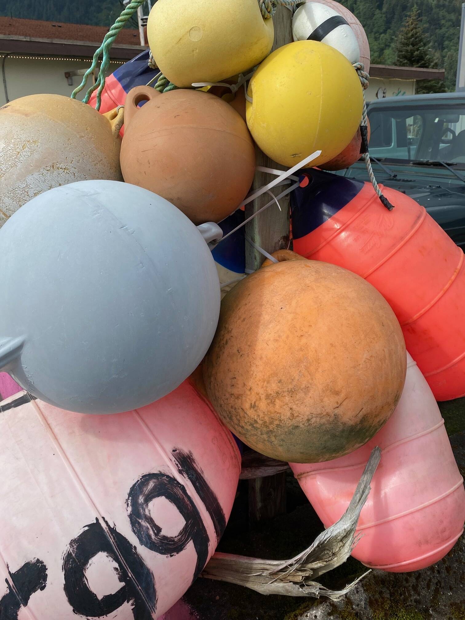 Colorful fishing buoys catch the sunlight near a town parking lot on Aug. 13. (Photo by Denise Carroll)